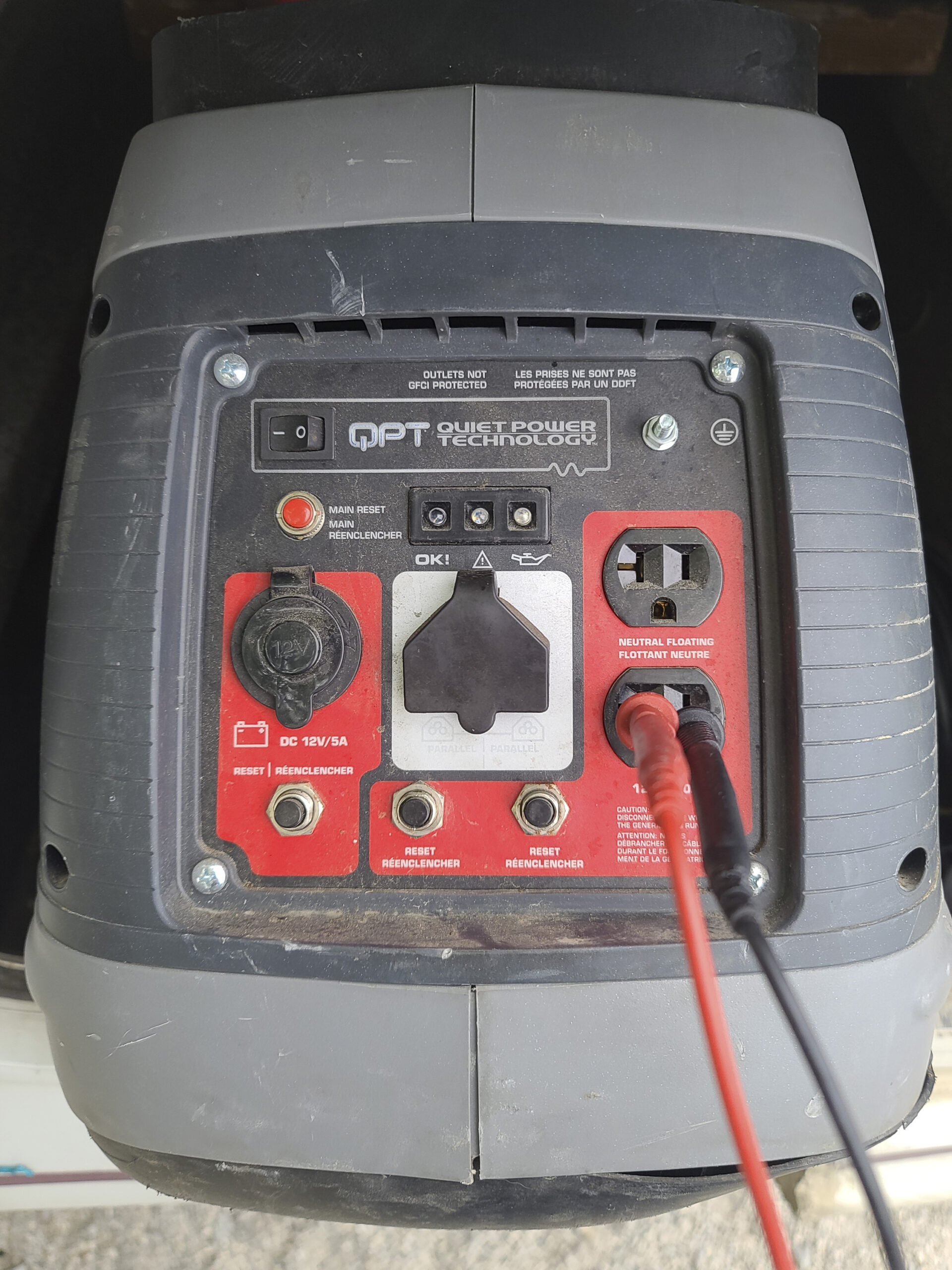 The front of a generator, showing the electrical connections and circuit breakers.