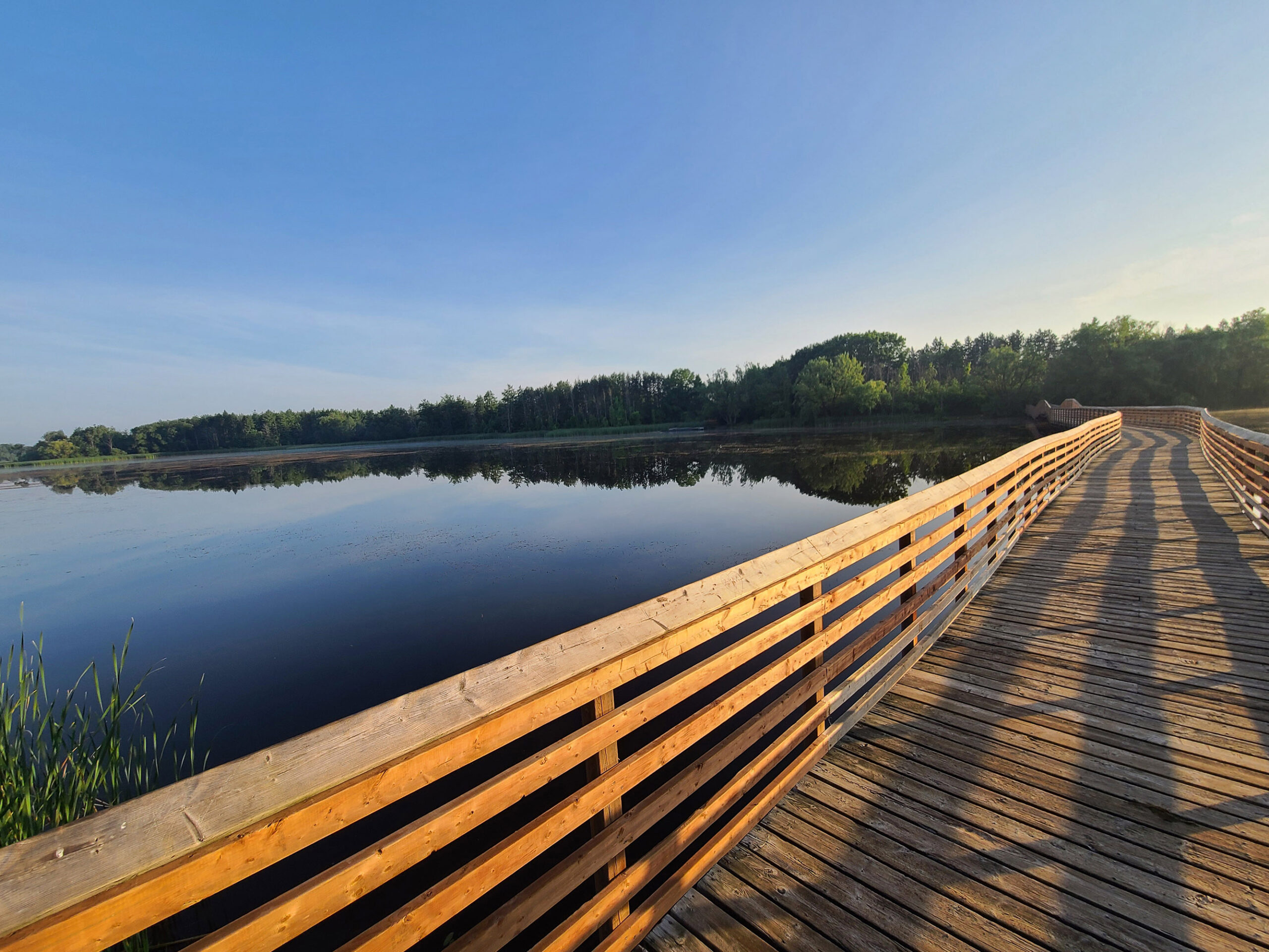 a wooden boardwalk over Valens Lake.