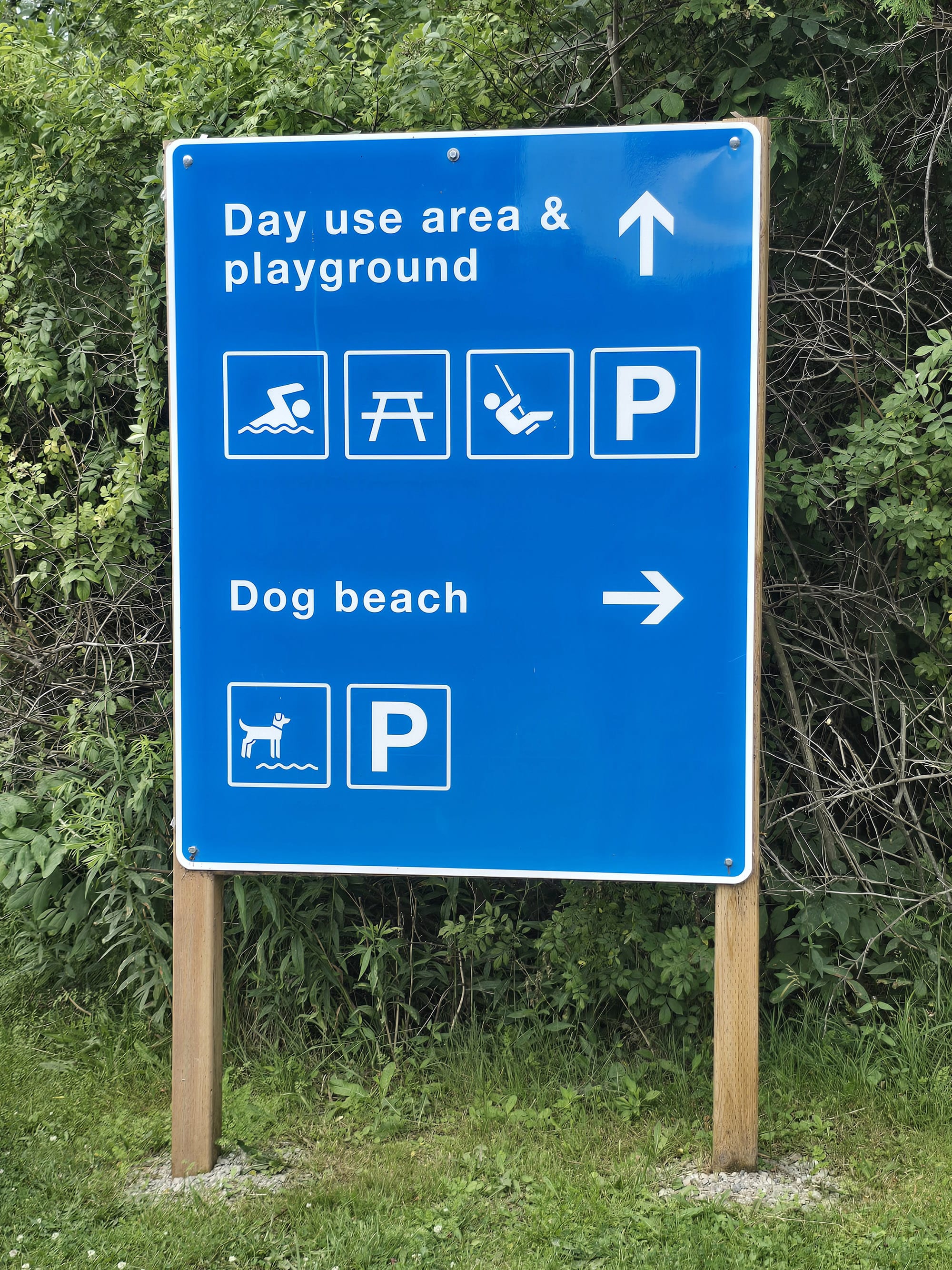 A blue and white directional road sign.