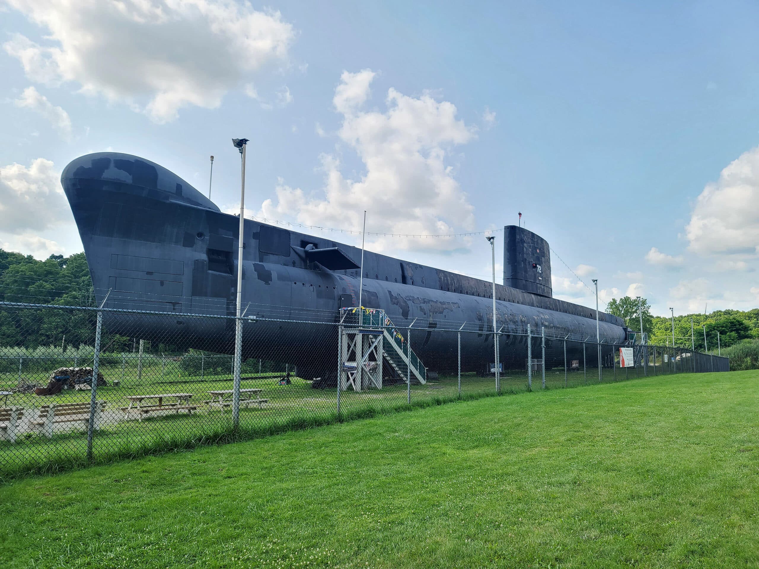 A large submarine on grass.