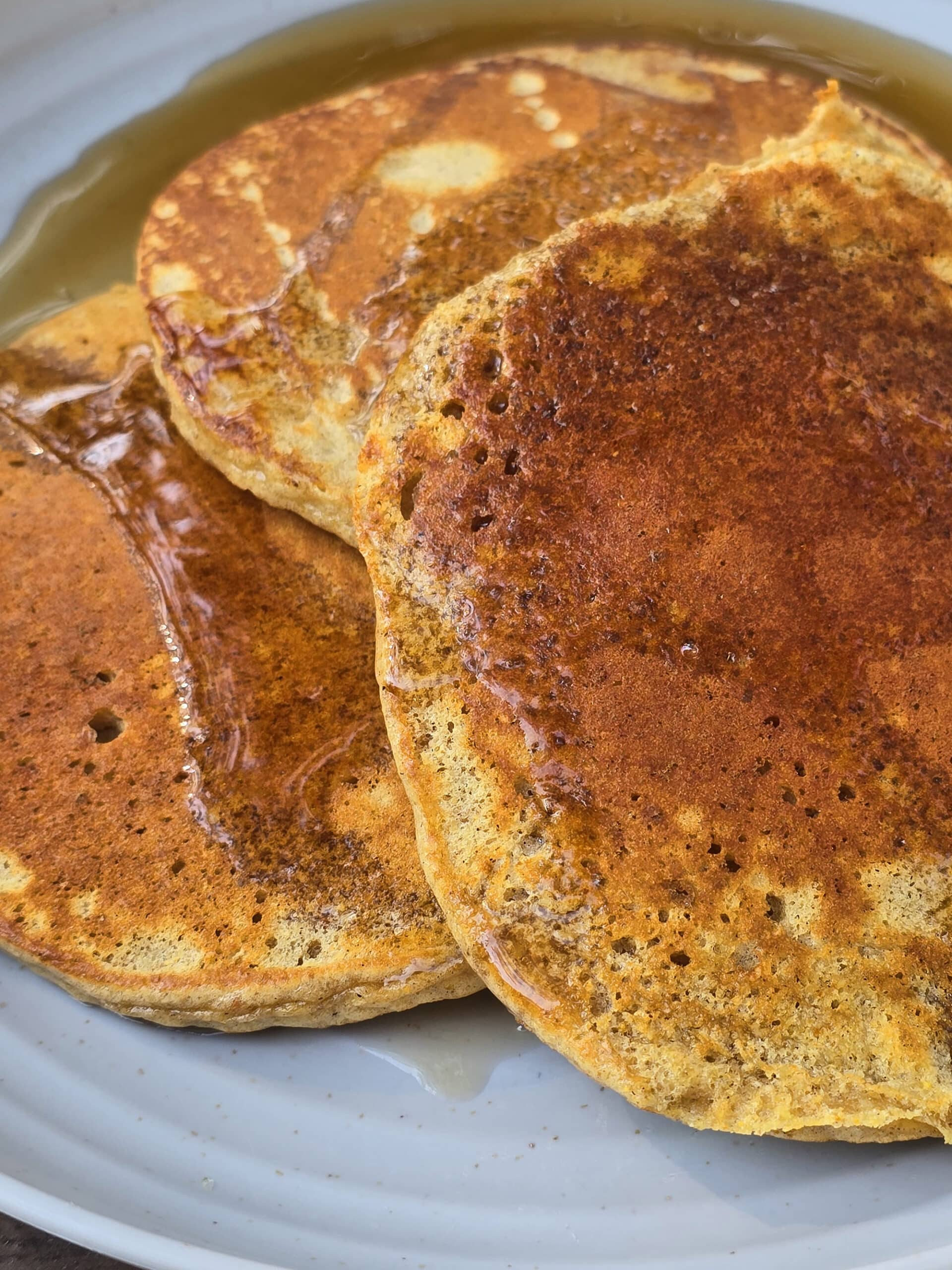 3 pumpkin protein pancakes on a camping plate.