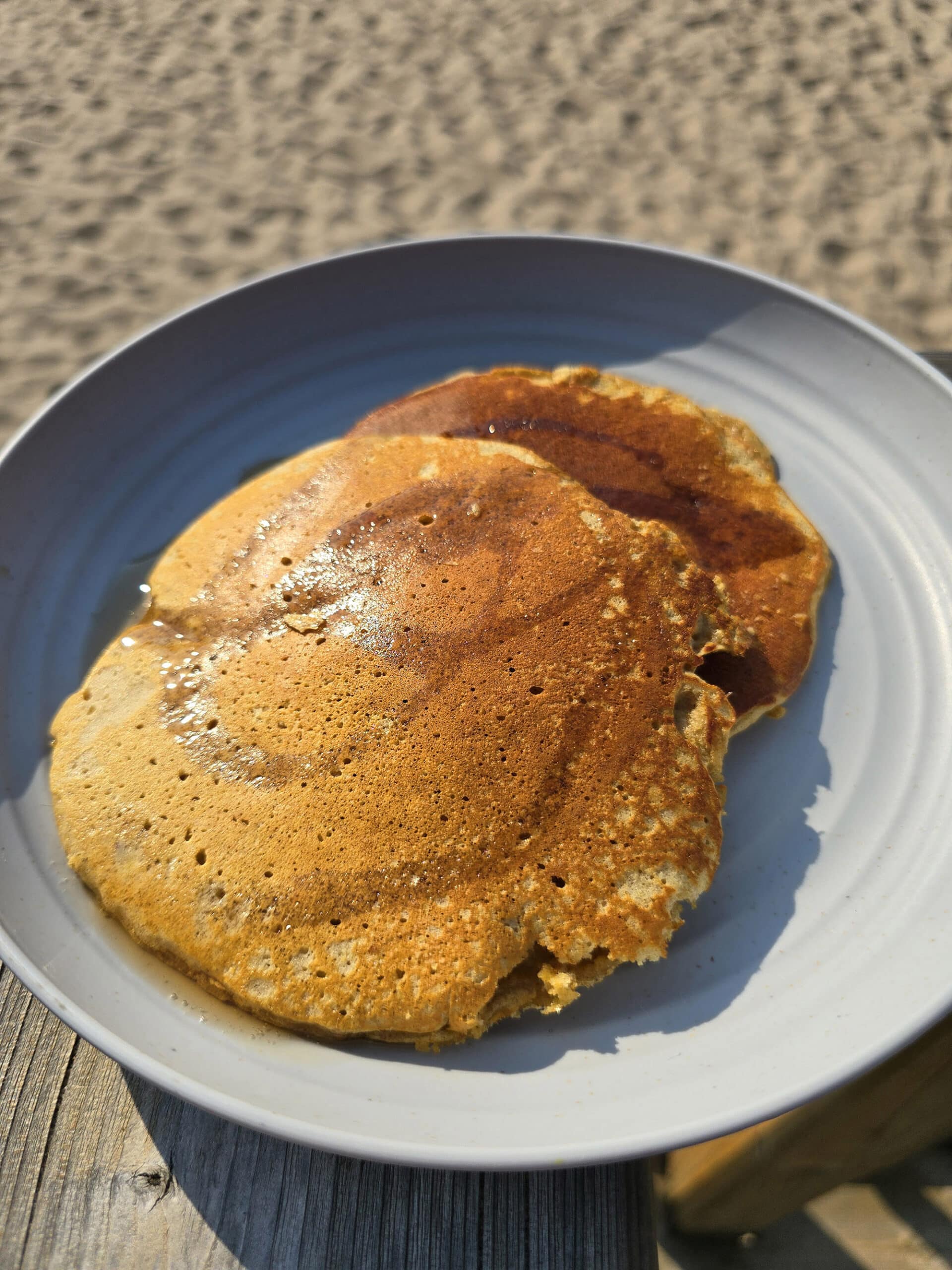 3 protein pumpkin pancakes on a camping plate.