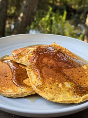 3 protein pumpkin pancakes on a camping plate.