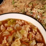 A bowl of keto egg roll soup in front of a bag of dry mix for the soup.