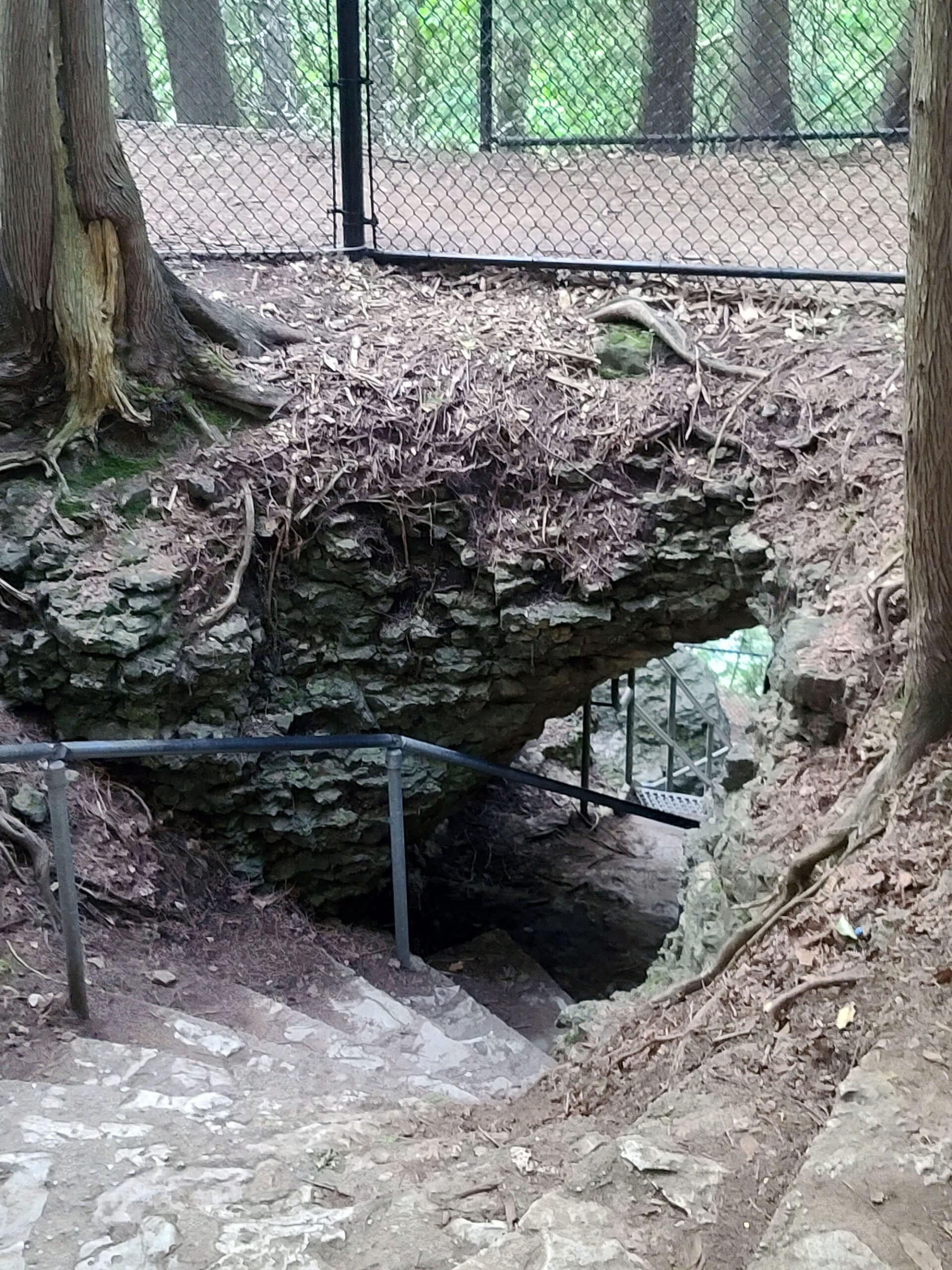 Stairs going through a large hole in the rock, at Elora Conservation Area.