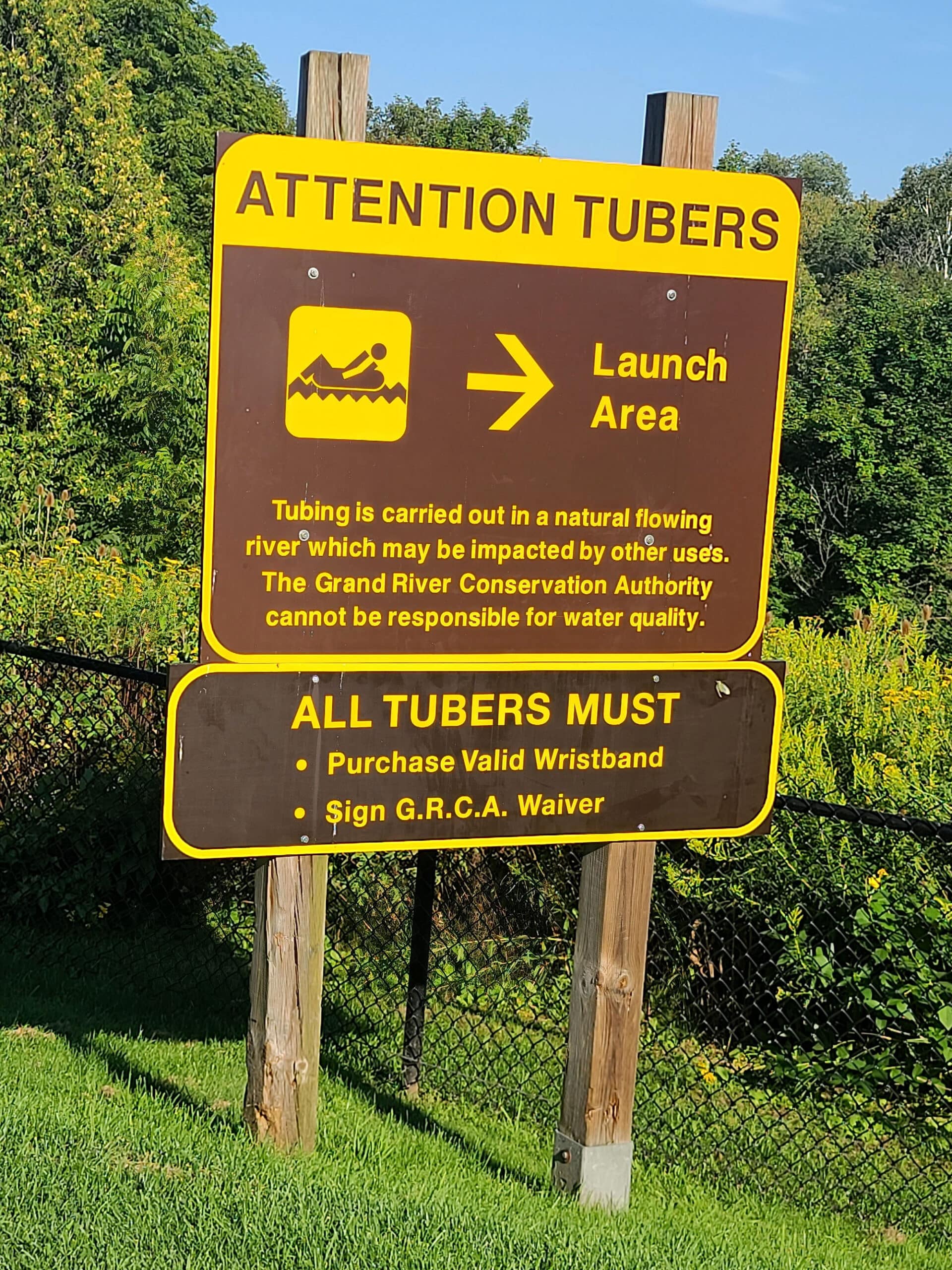 A sign pointing out the launch area for the Elora Gorge Tubing experience.