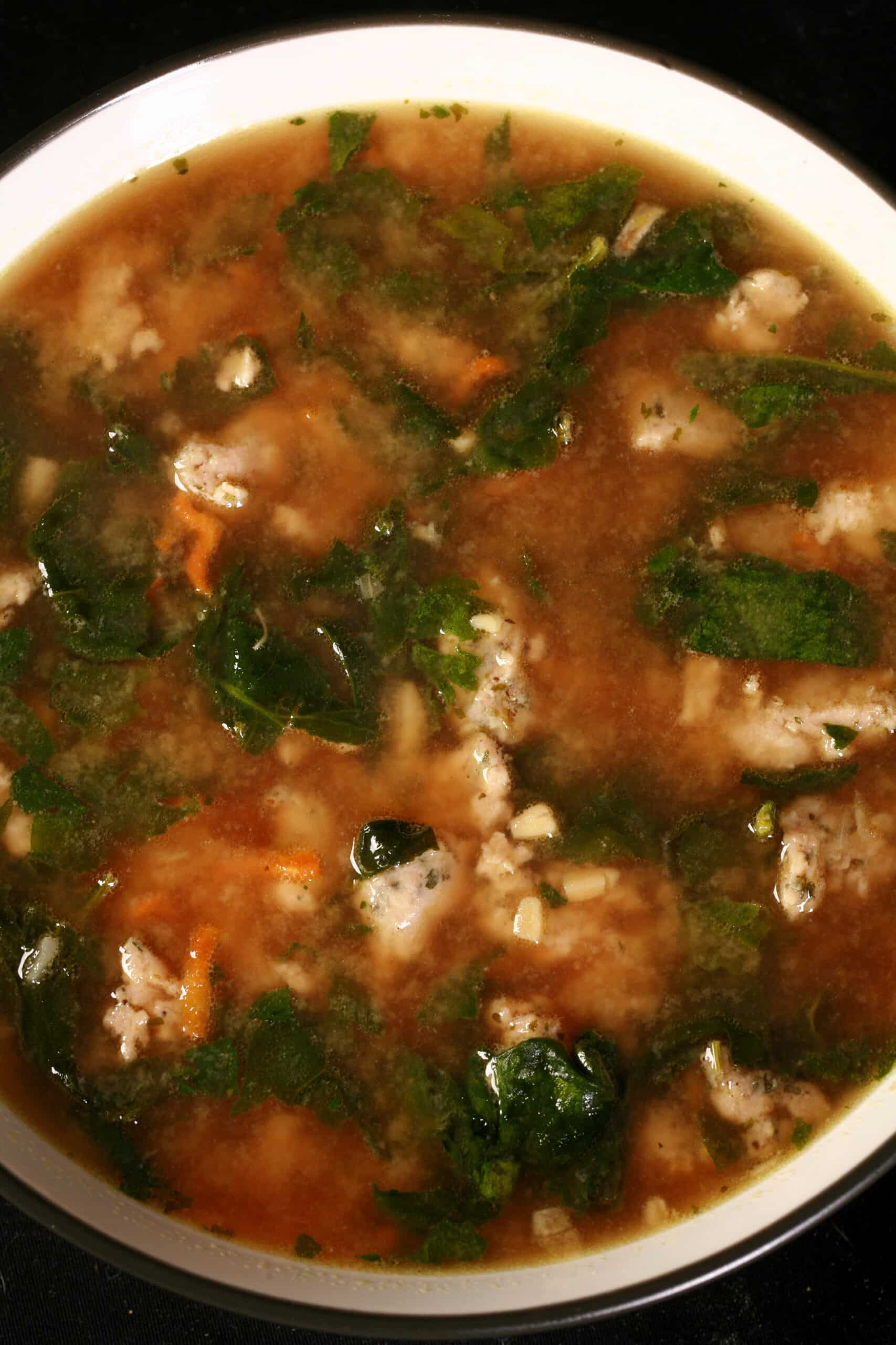 A bowl of homemade gluten free italian wedding soup made from a dry mix.