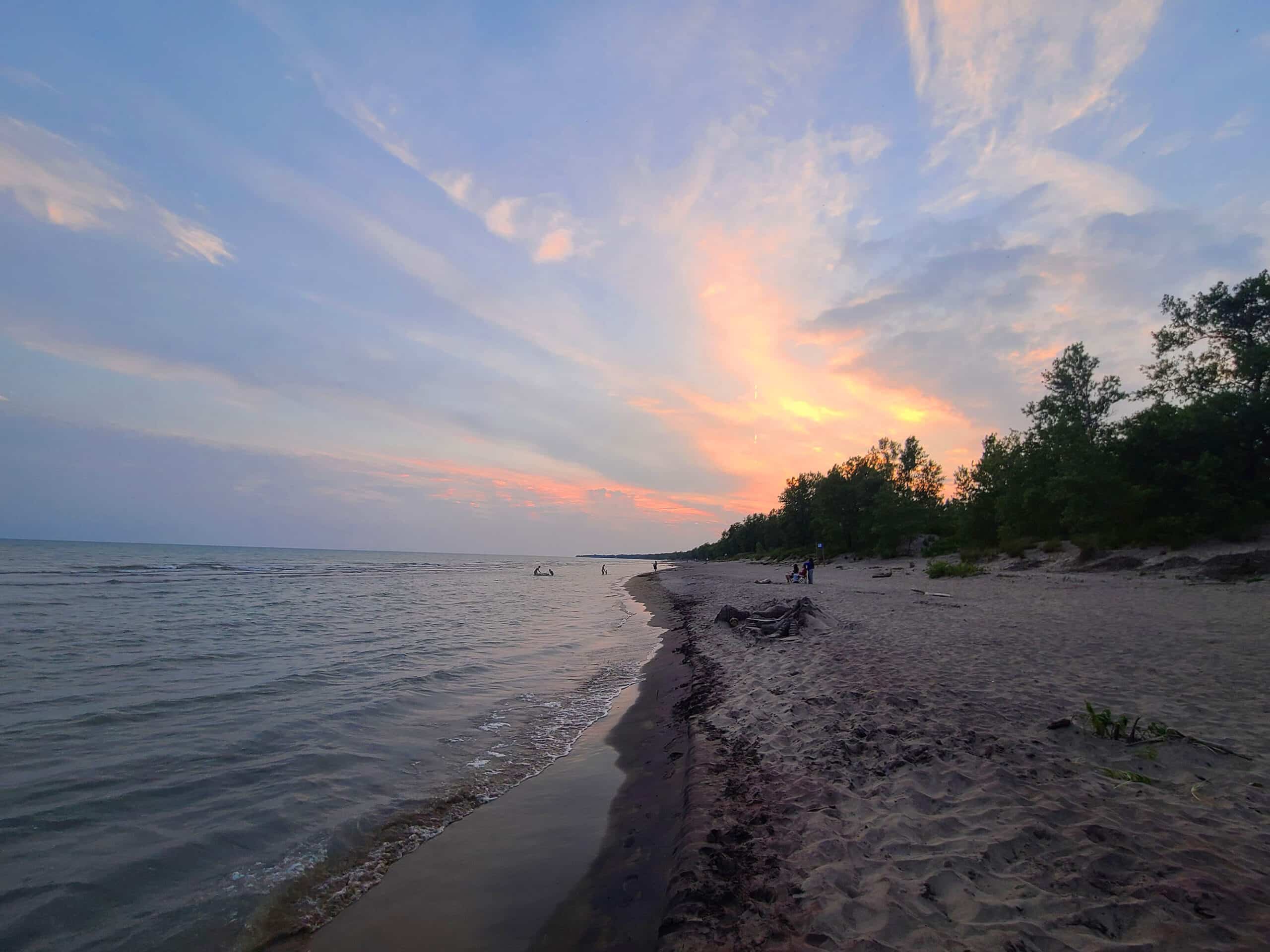 The sun setting over lake erie at Long Point provincial park.