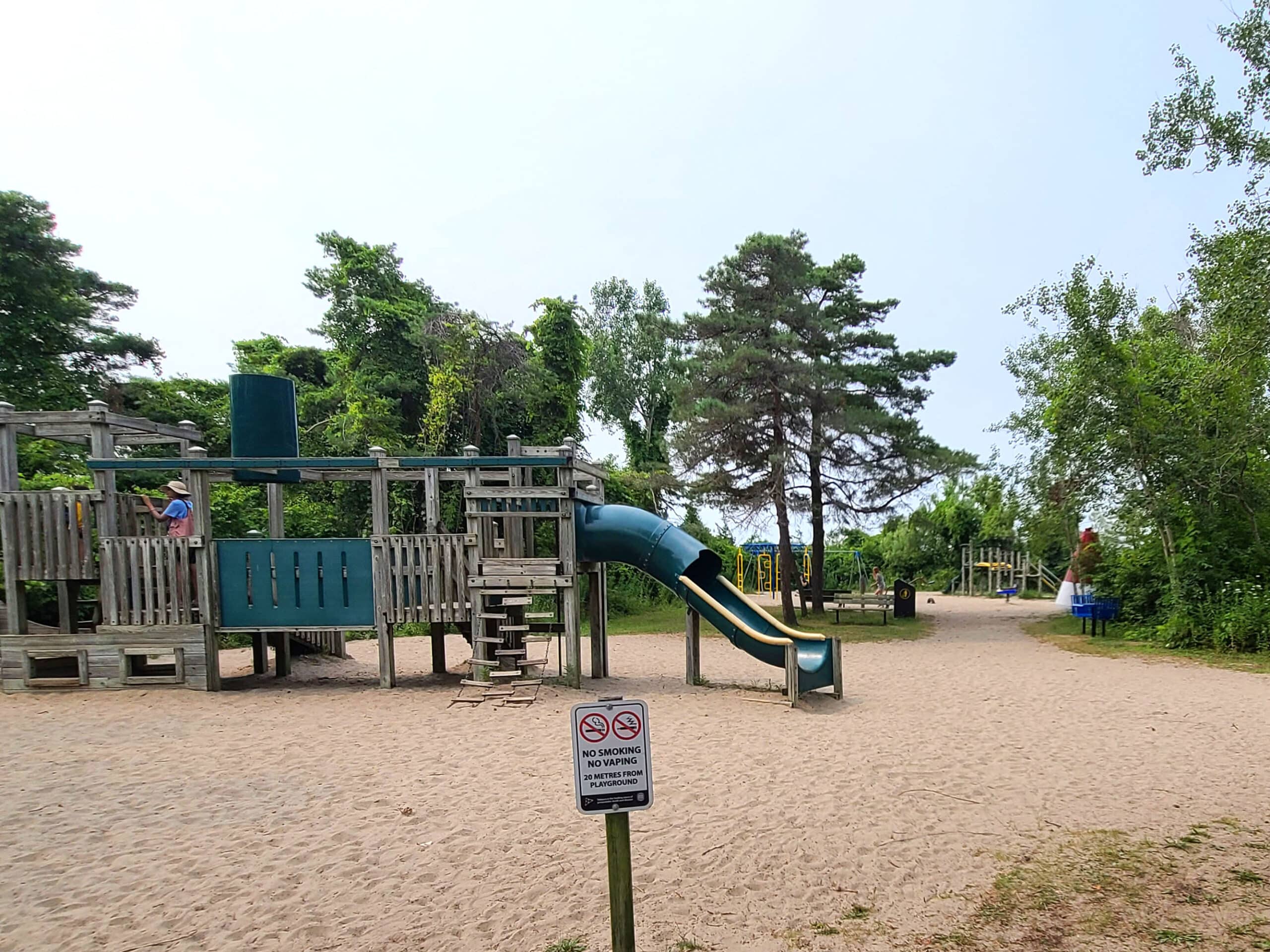 2 large playground sets on sand.