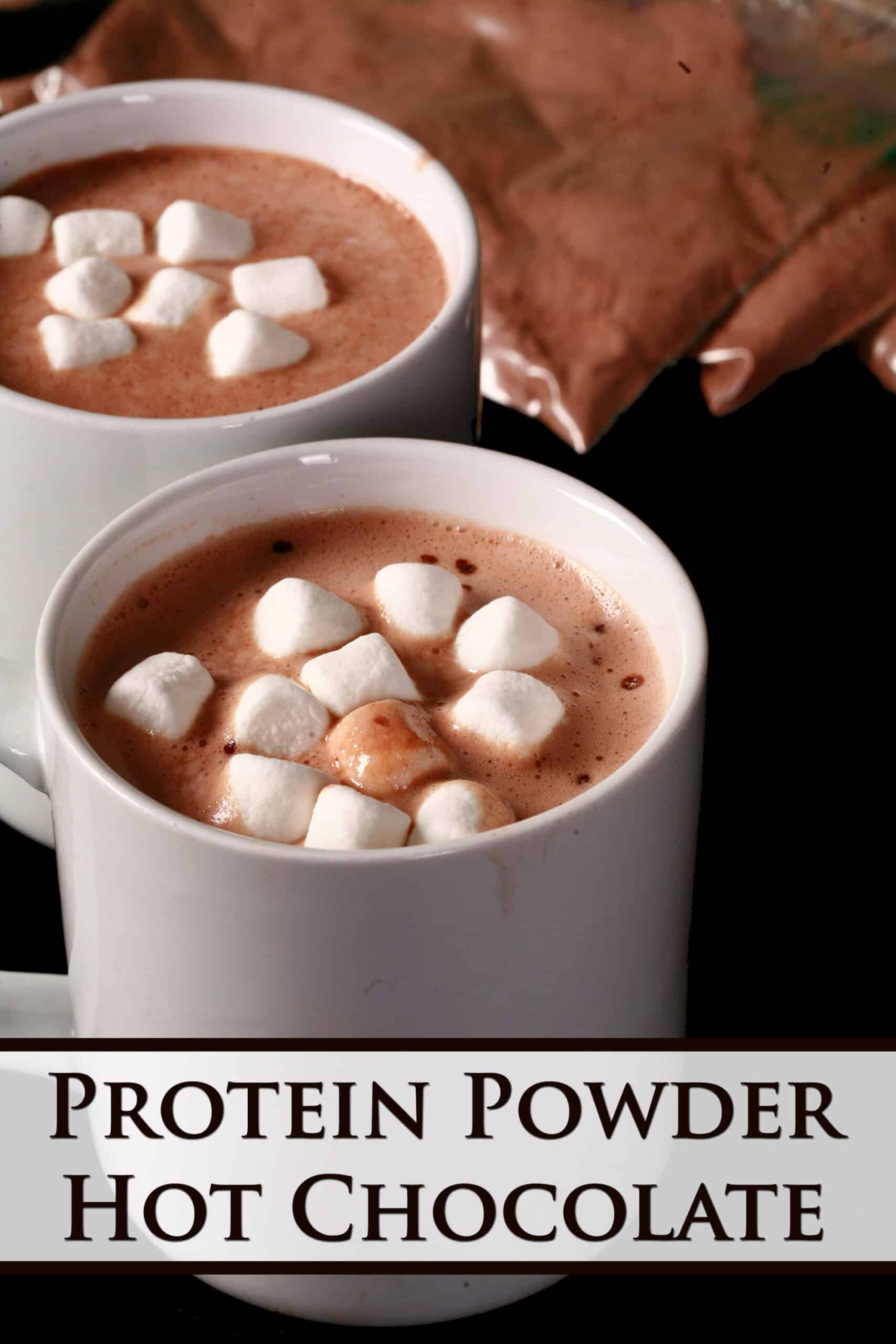 2 mugs of protein hot chocolate and several baggies of mix.  Overlaid text says protein powder hot chocolate.