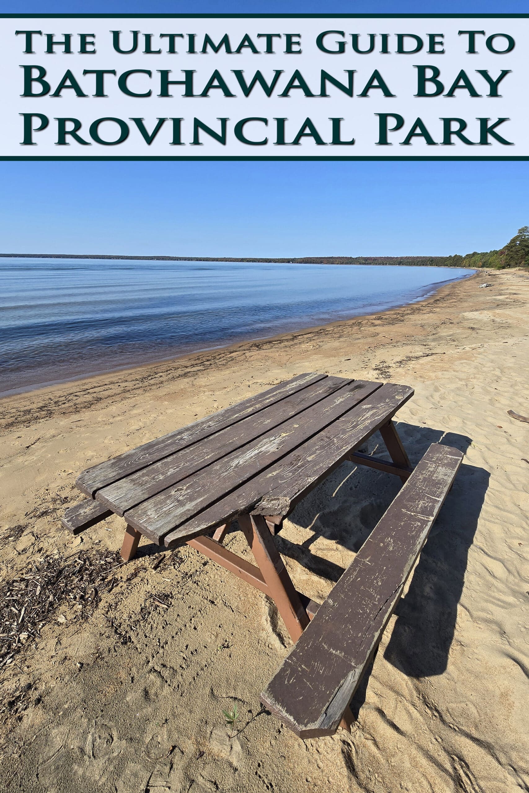 A picnic table on a beach, with Lake Superior behind it. Overlaid text says The Ultimate Guide to Batchawana Bay Provincial Park.