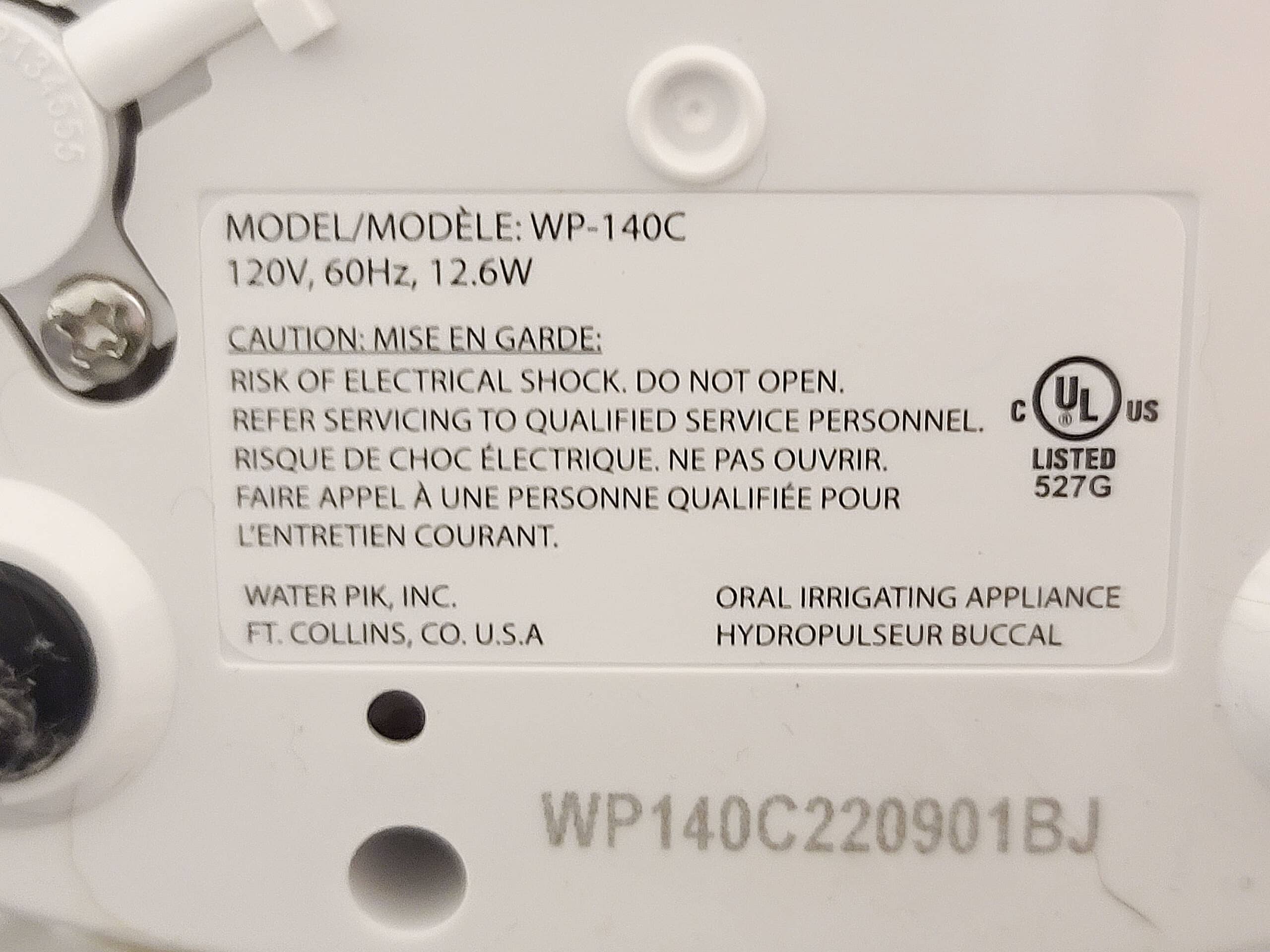 An electrical label on a waterpik flosser stating power used and other information.