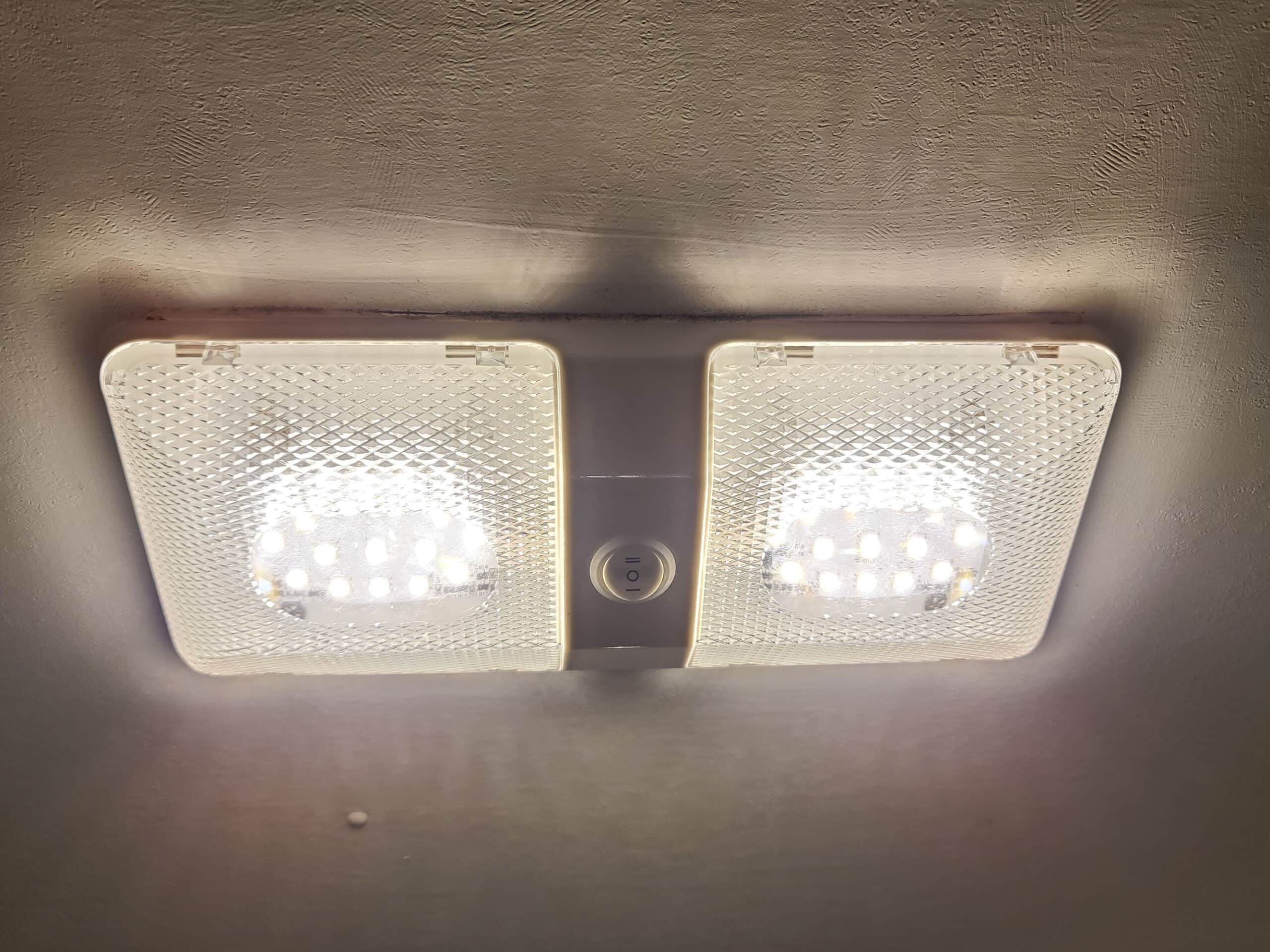 A closeup of an RV double sided LED light mounted on the ceiling.