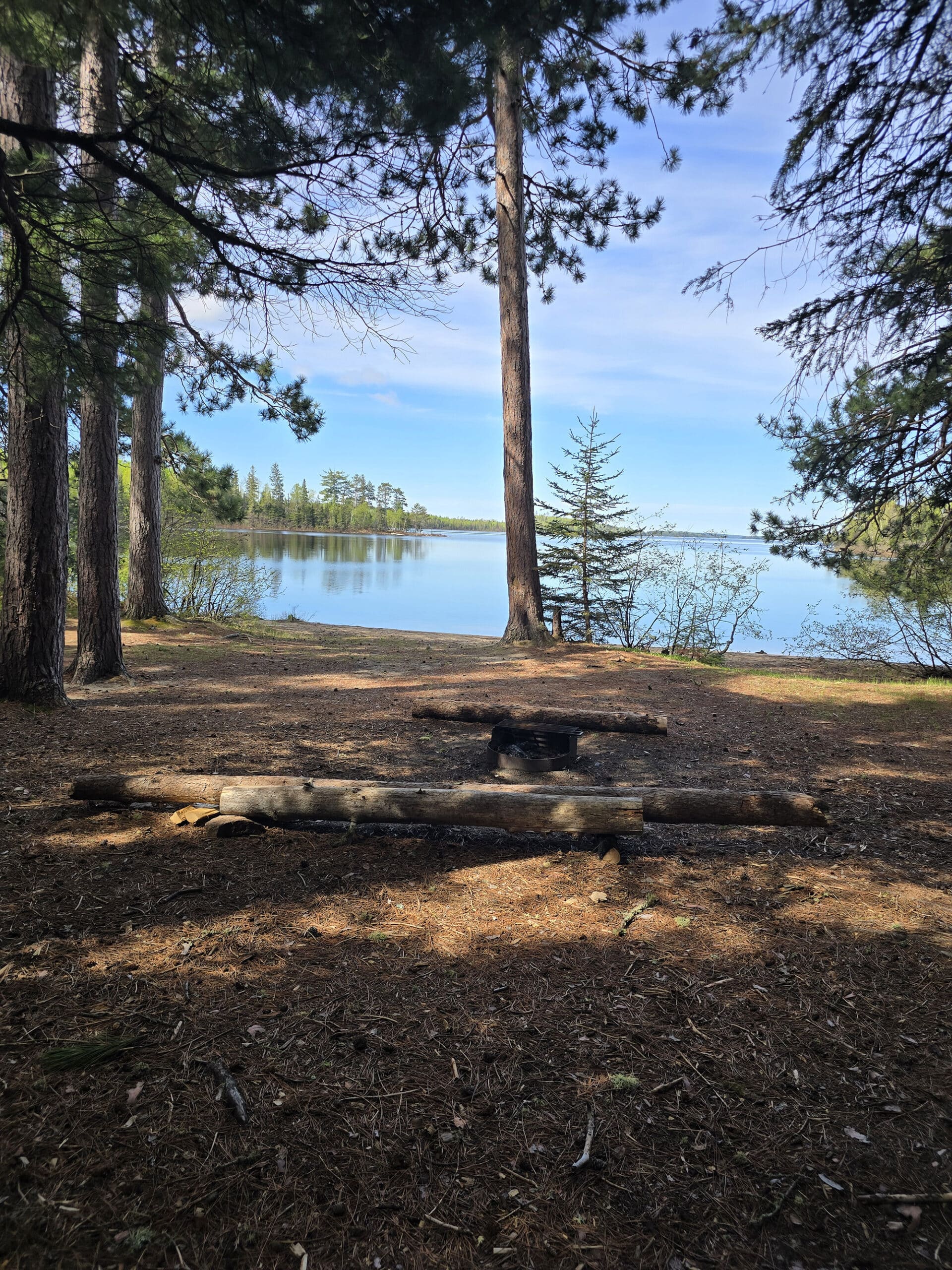 A remote camping site with a lake in the background.