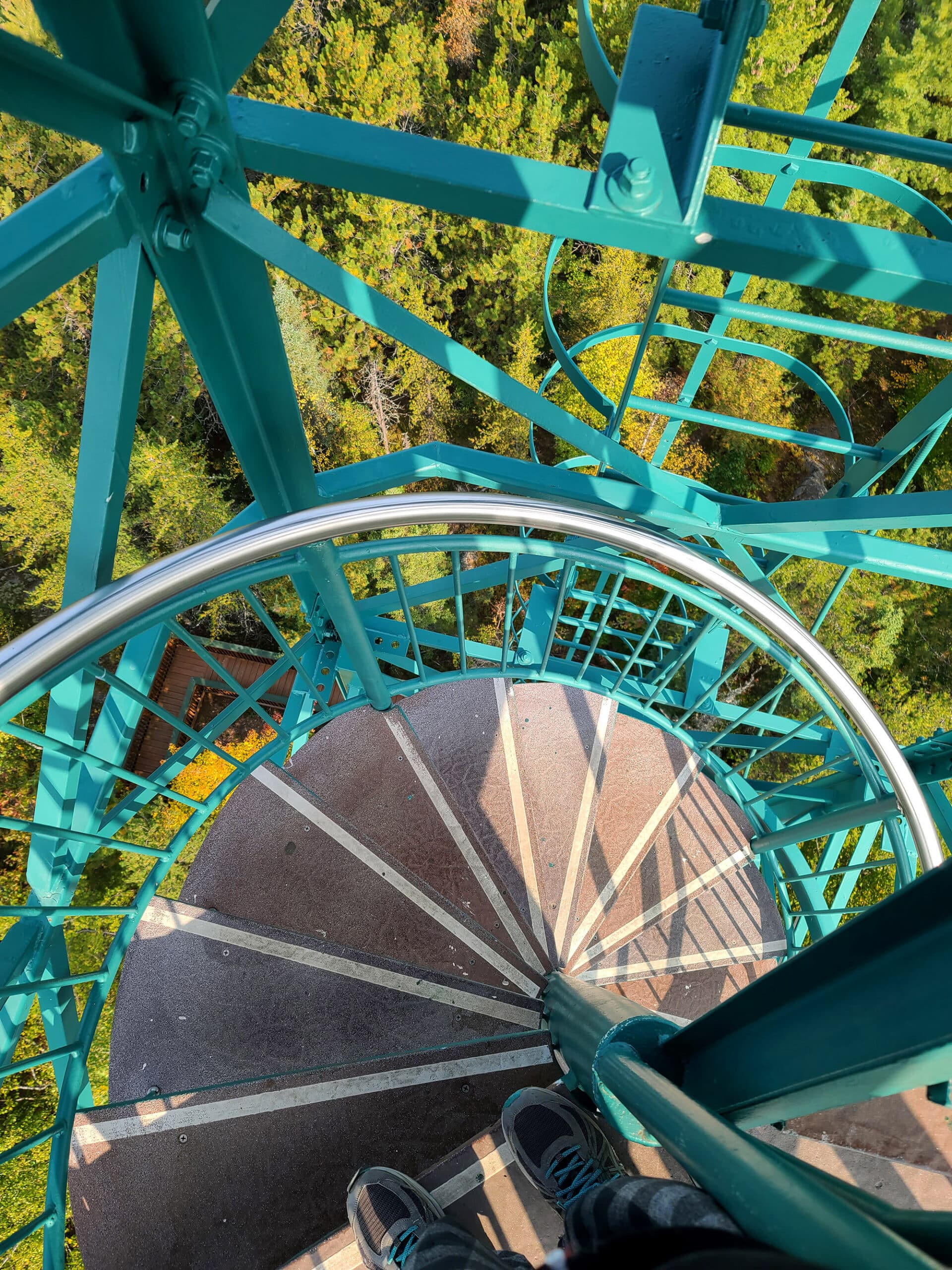 Light teal coloured metal spiral staircase leading up the temagami fire tower.