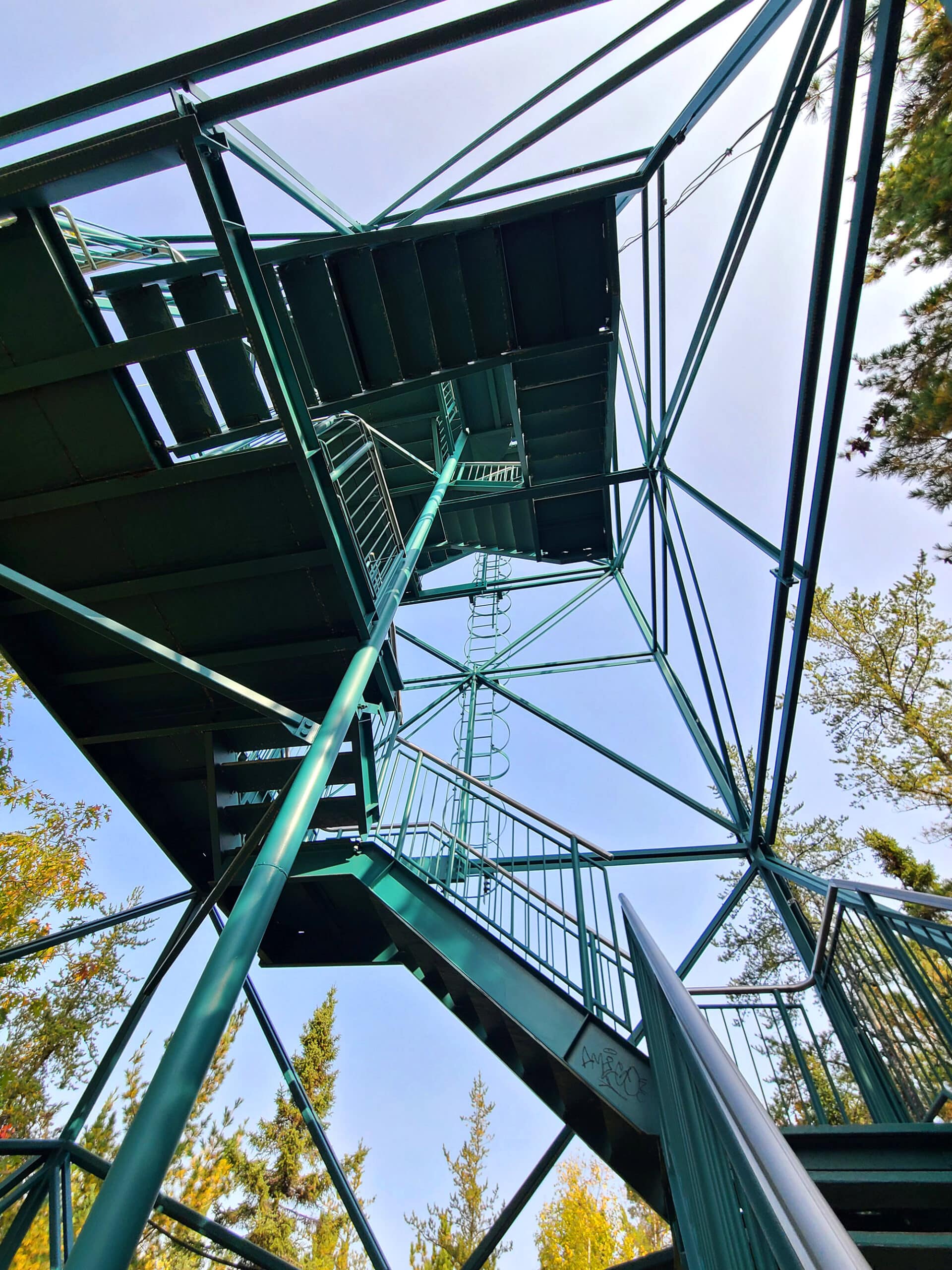 Light teal coloured metal staircase leading up the temagami fire tower.