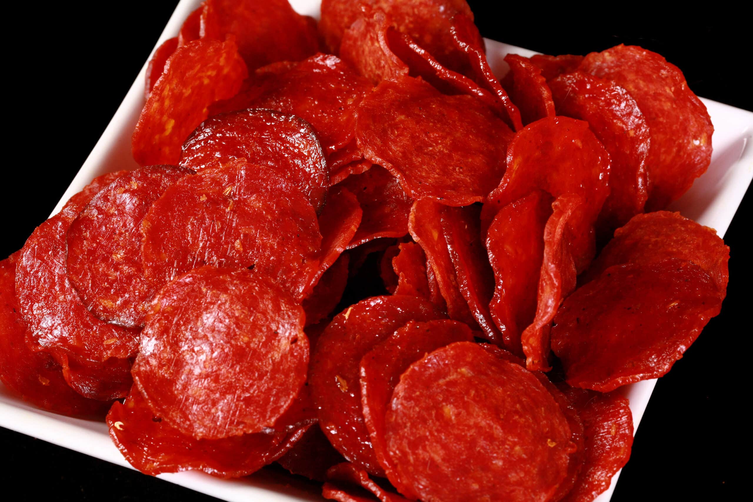 A bowl of pepperoni jerky slices.