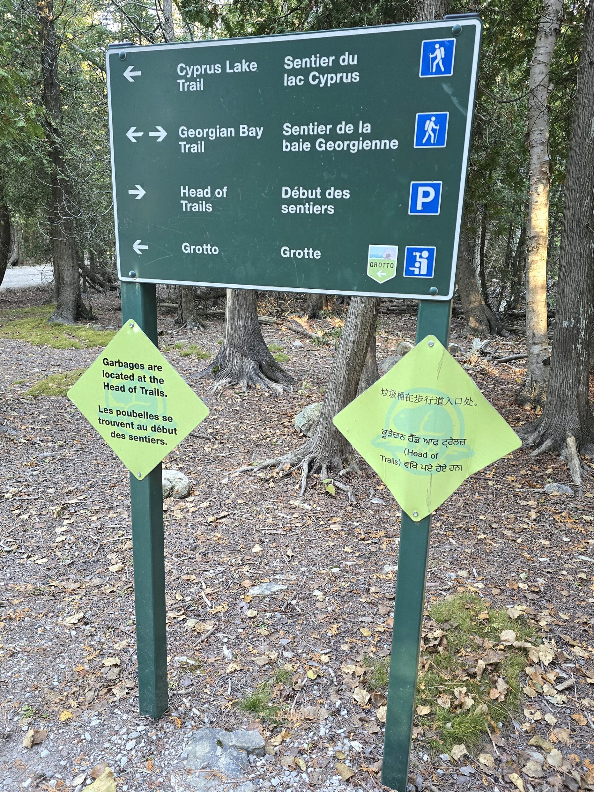 A Bruce Peninsula National Park sign showing directions in multiple languages.