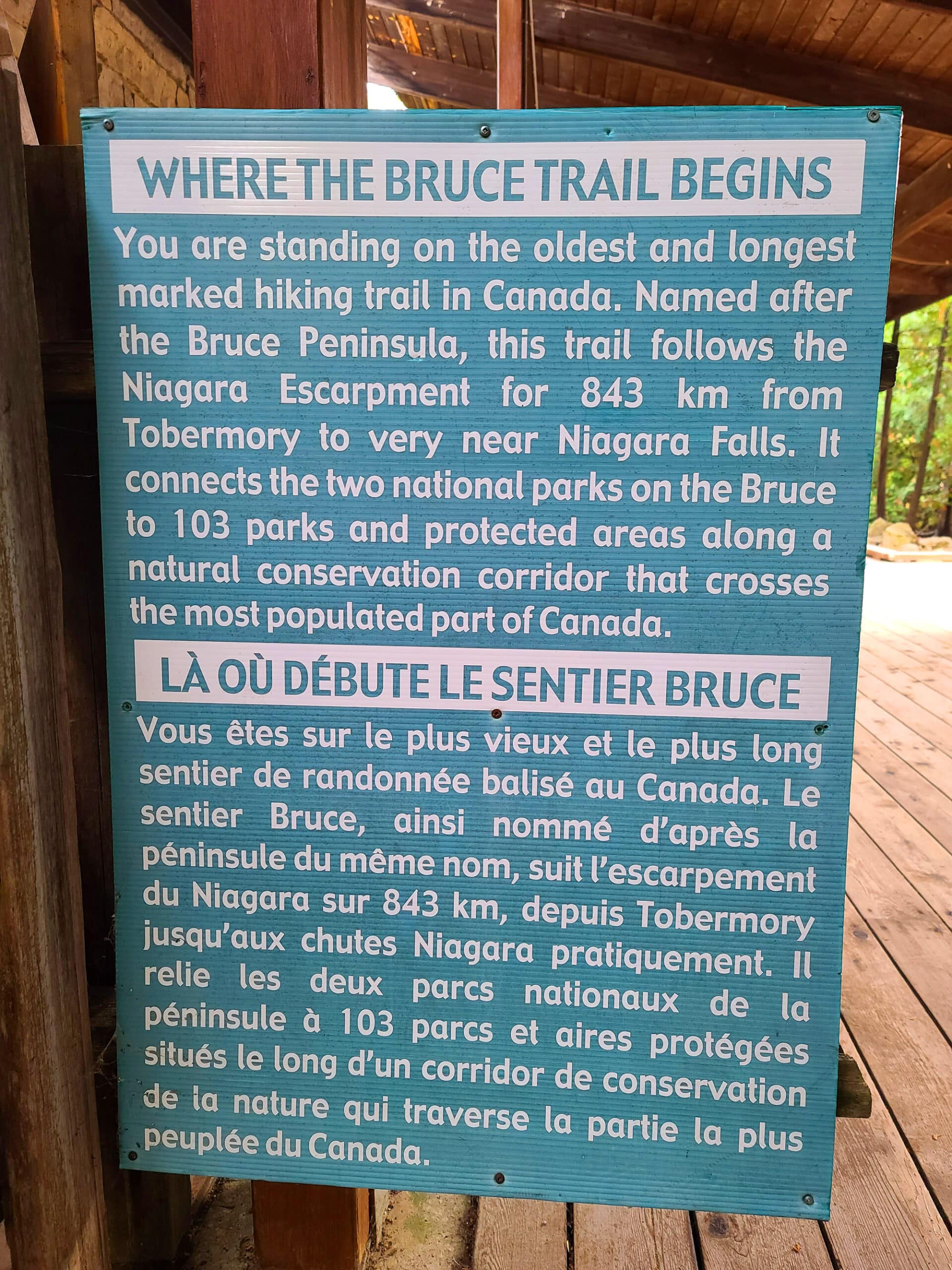 A turquoise trail sign, talking about the bruce trail.