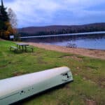 A canoe in the grass, next to Canisbay Lake.