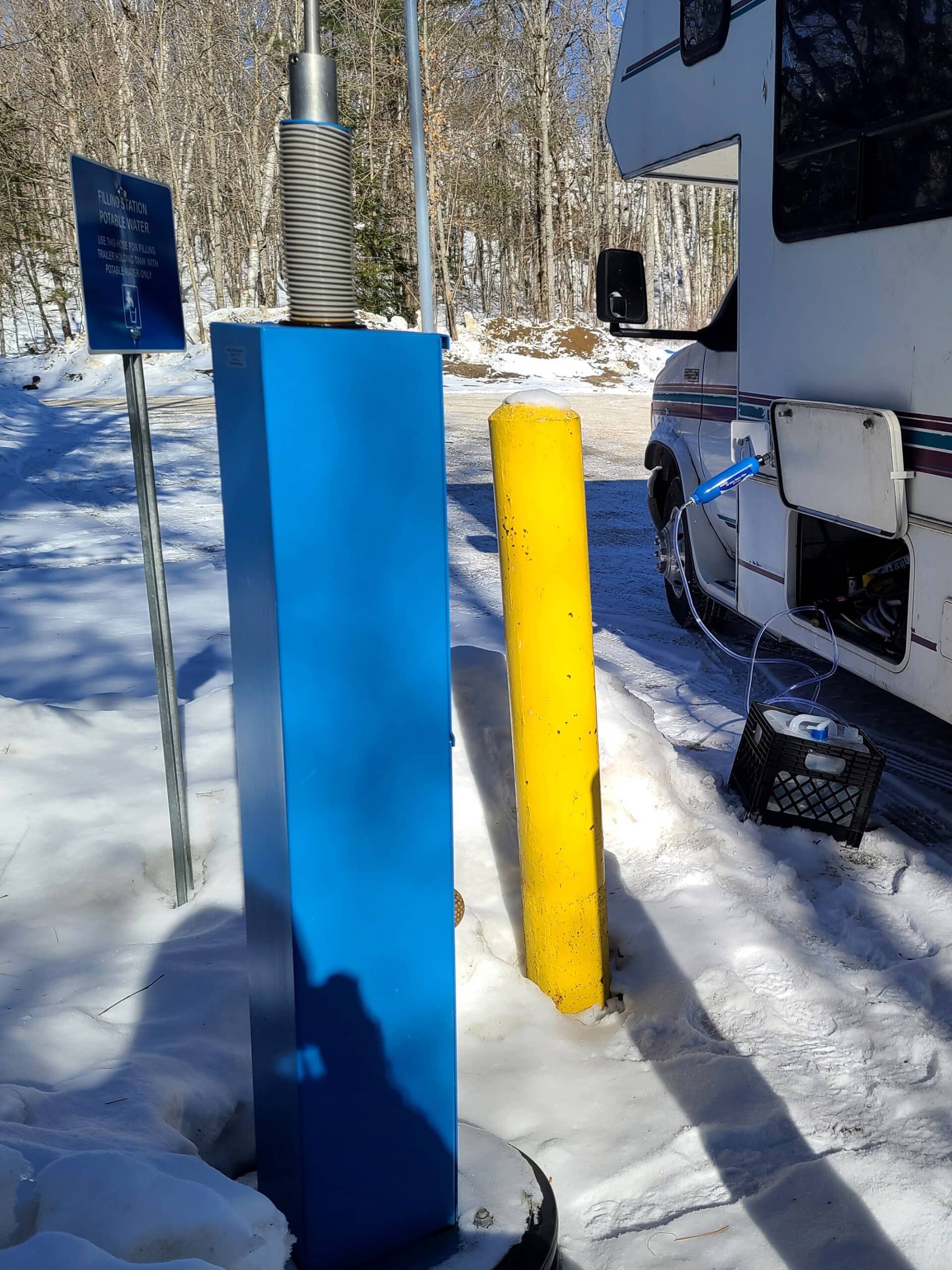 An outdoor water tap, in the winter.