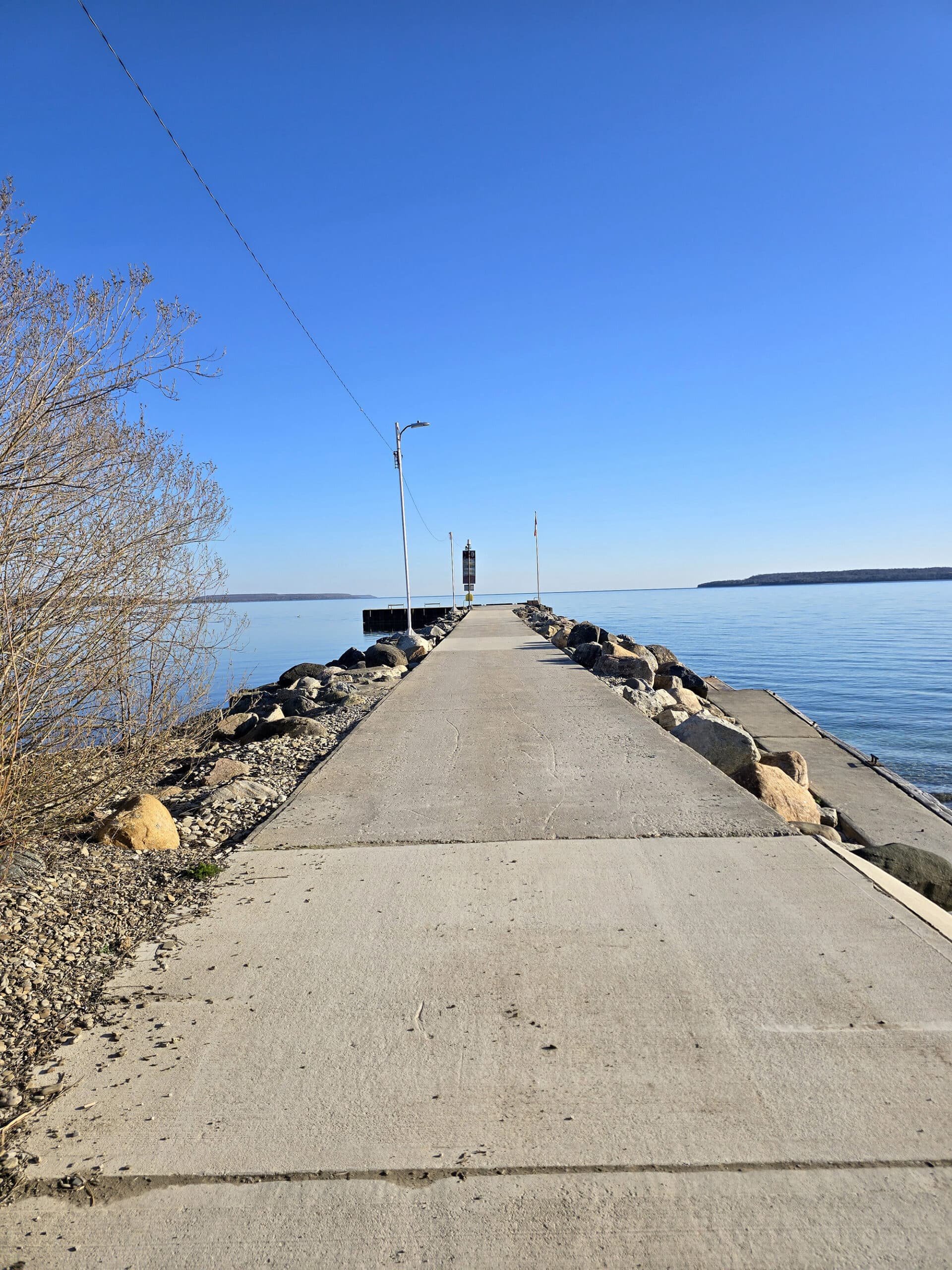 A large concrete pier extending into Georgian Bay, in Big Bay.