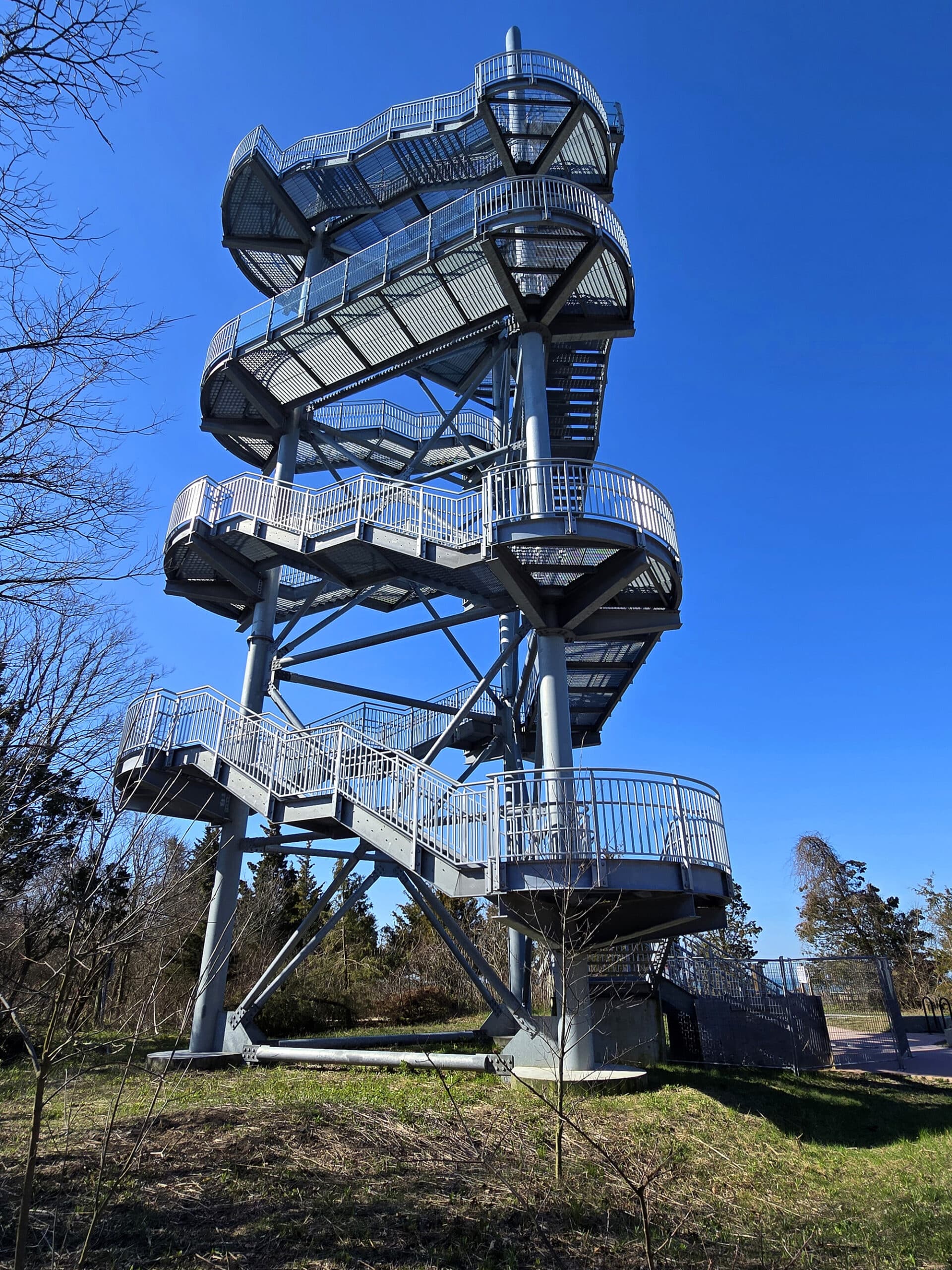 A tall metal tower with a large spiral staircase.