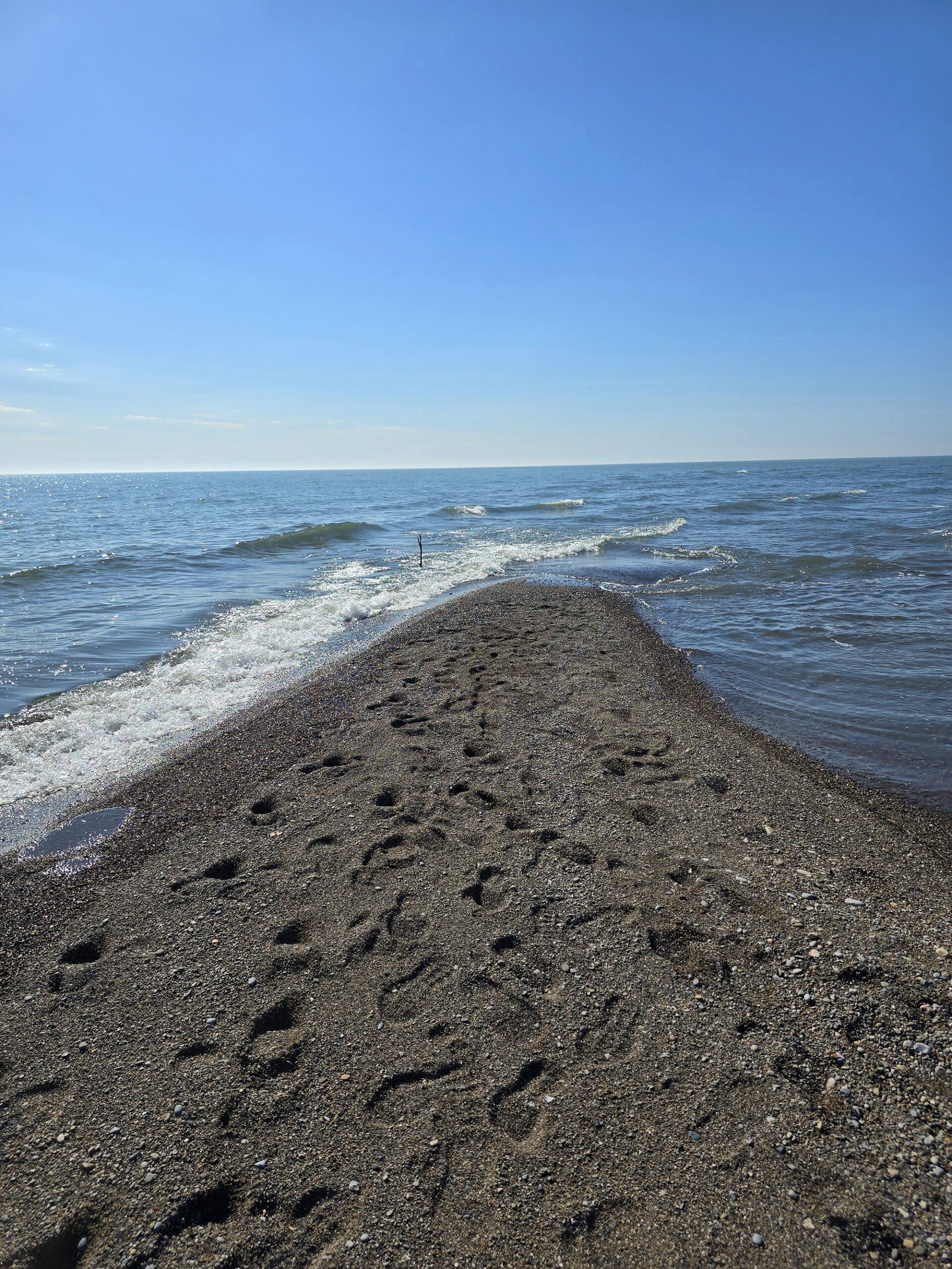 A narrow bar of sand extending into Lake Erie.