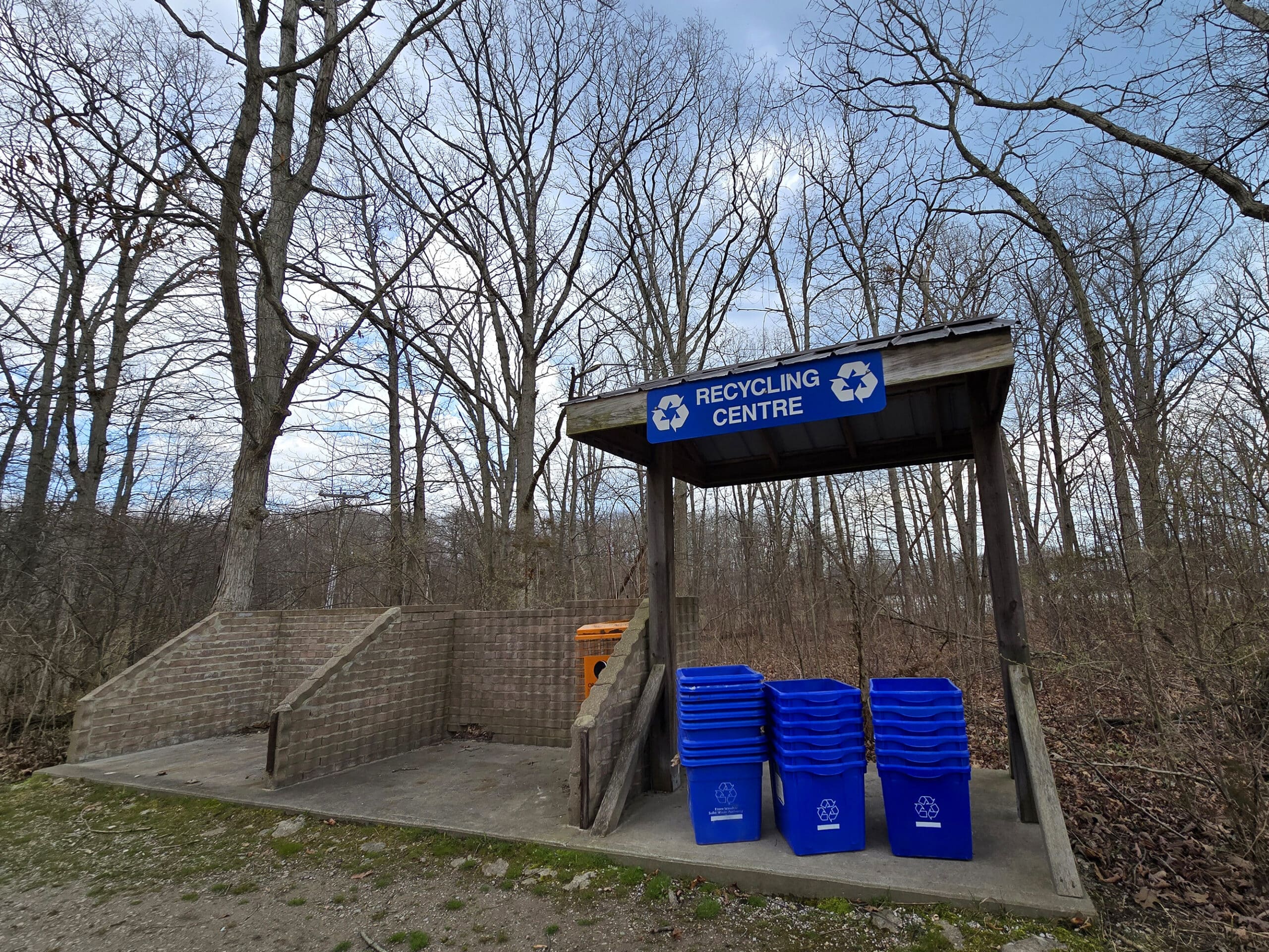 A small garbage and recycling area in a campground.