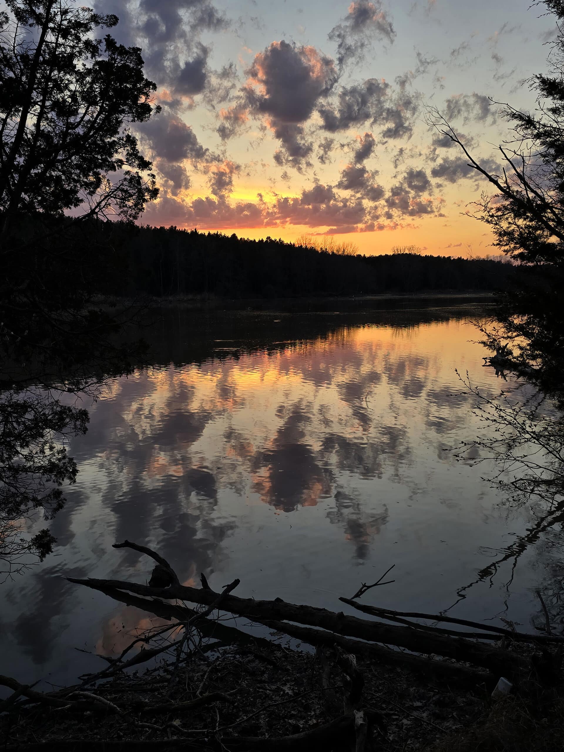 A pink and purple sunset over a creek at wheatley provincial park.