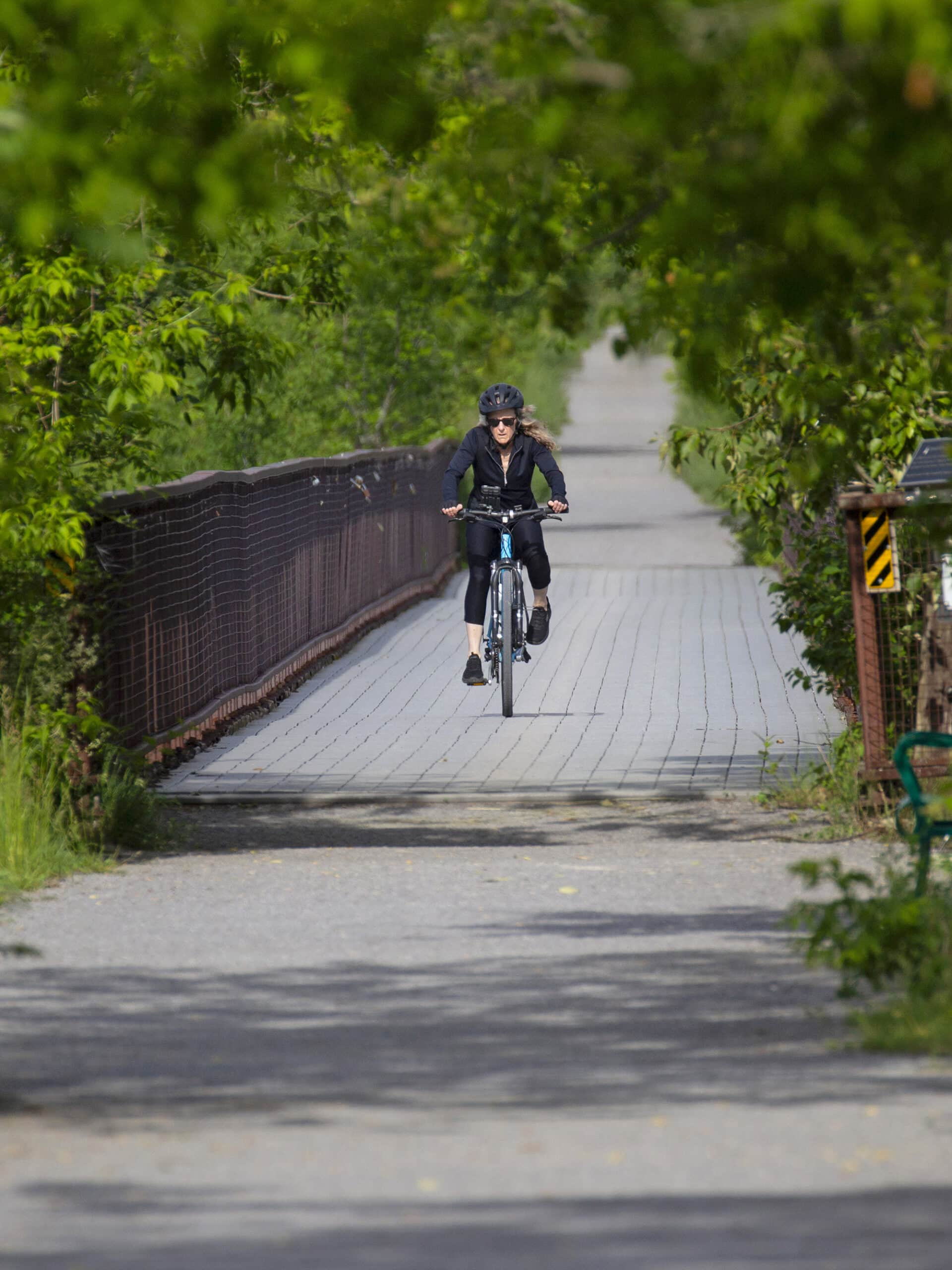 A cycling biking across Doube’s Trestle Bridge.