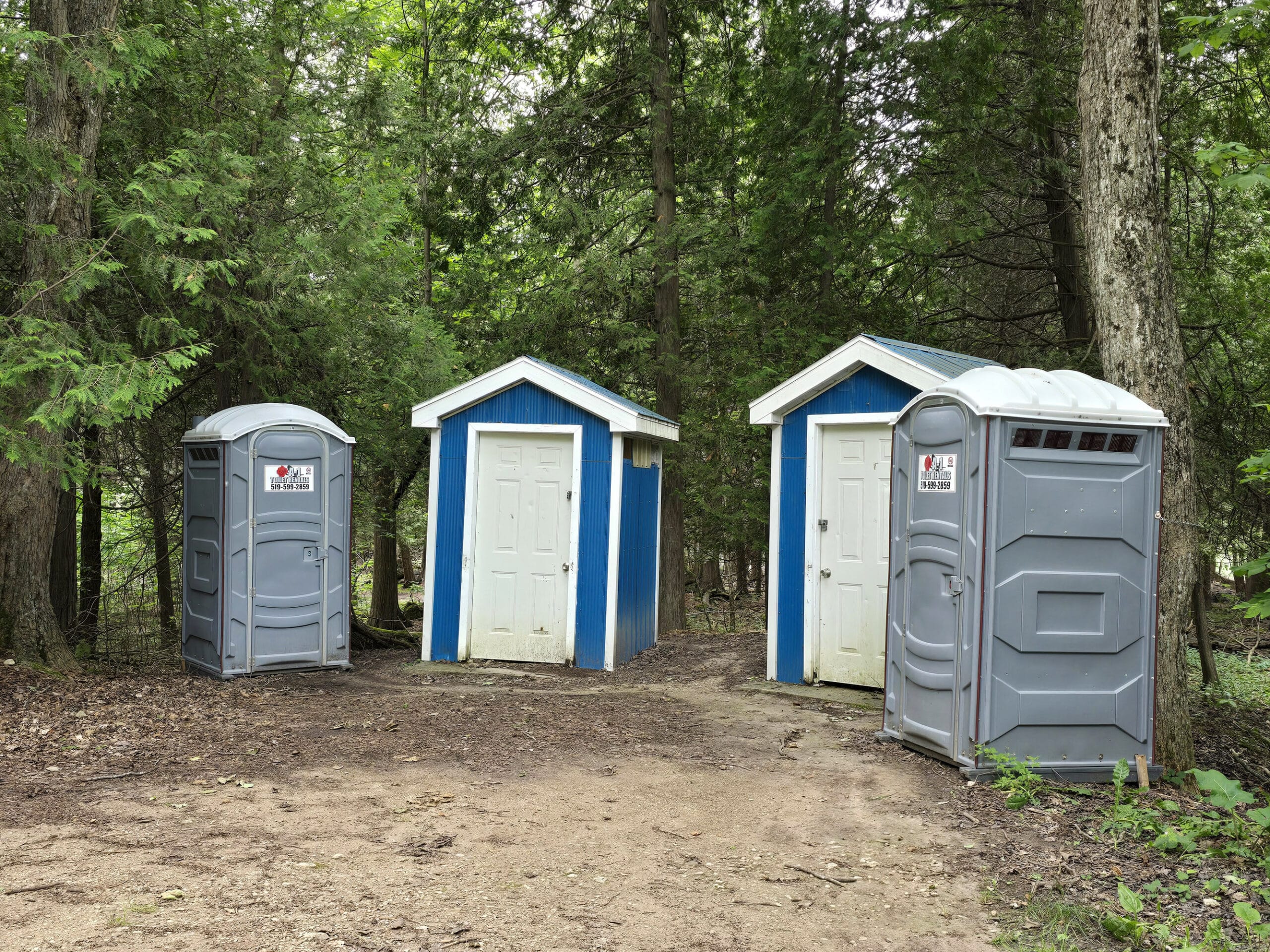 2 little blue huts, with 2 porta potties.