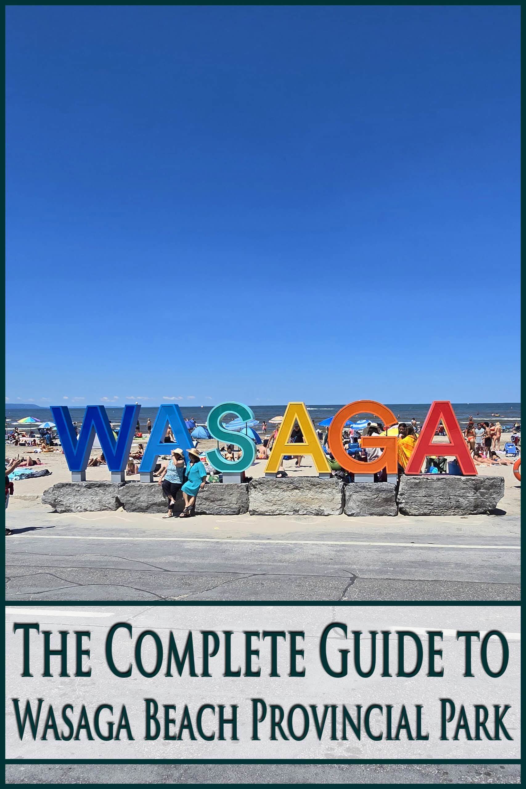 Rainbow letters spelling out wasaga, with loads of people behind it. Overlaid text says the complete guide to wasaga beach provincial park.