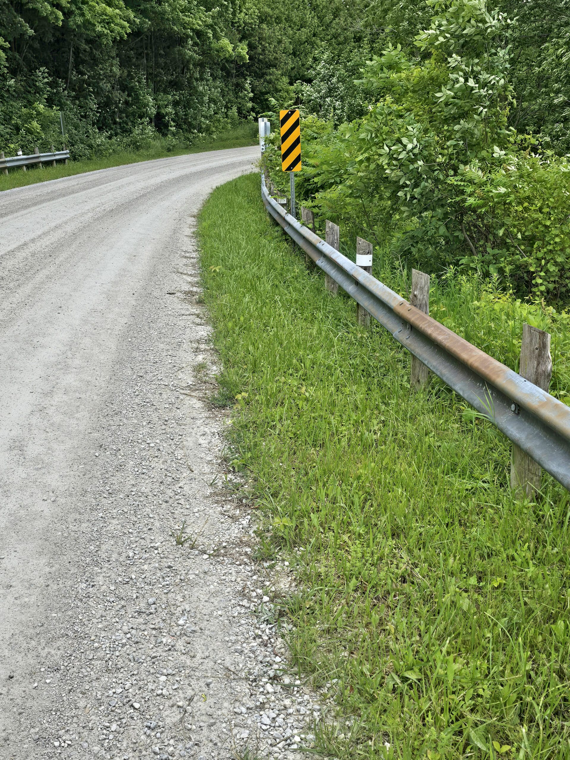 A road with a metal guard rail.