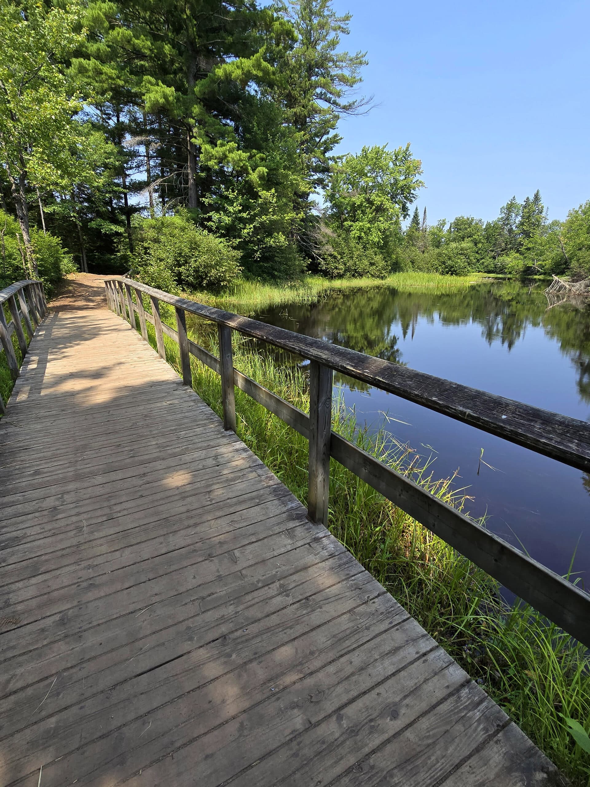 A wooden foot bridge crossing the Bonnechere river.