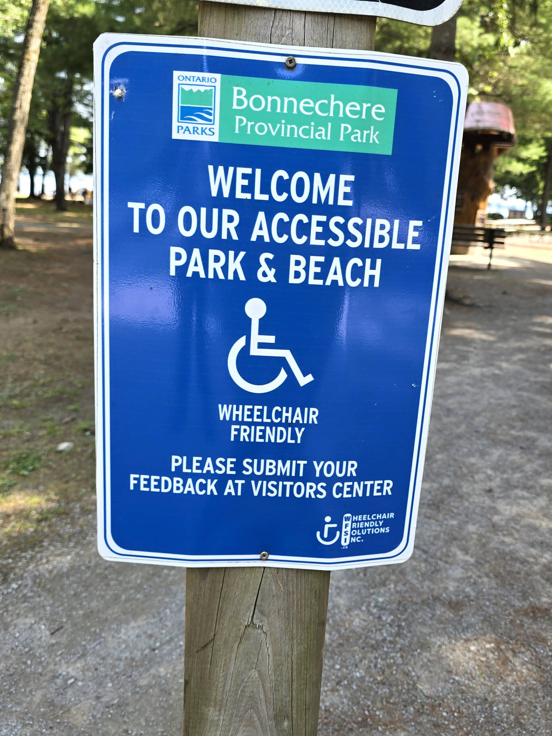 A park sign welcoming people to the accessible beach.