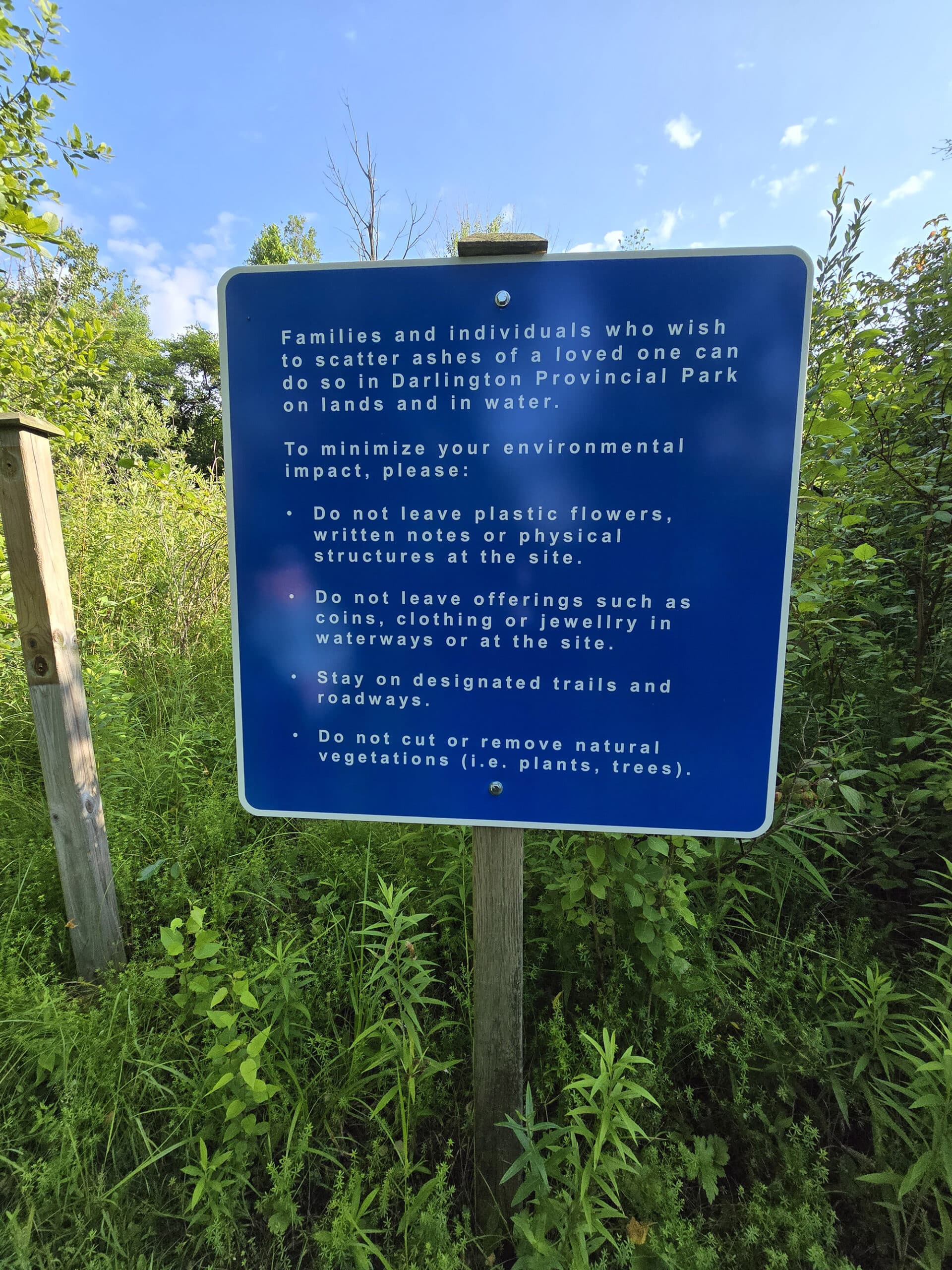 A sign talking about the spreading of cremated remains in the park.