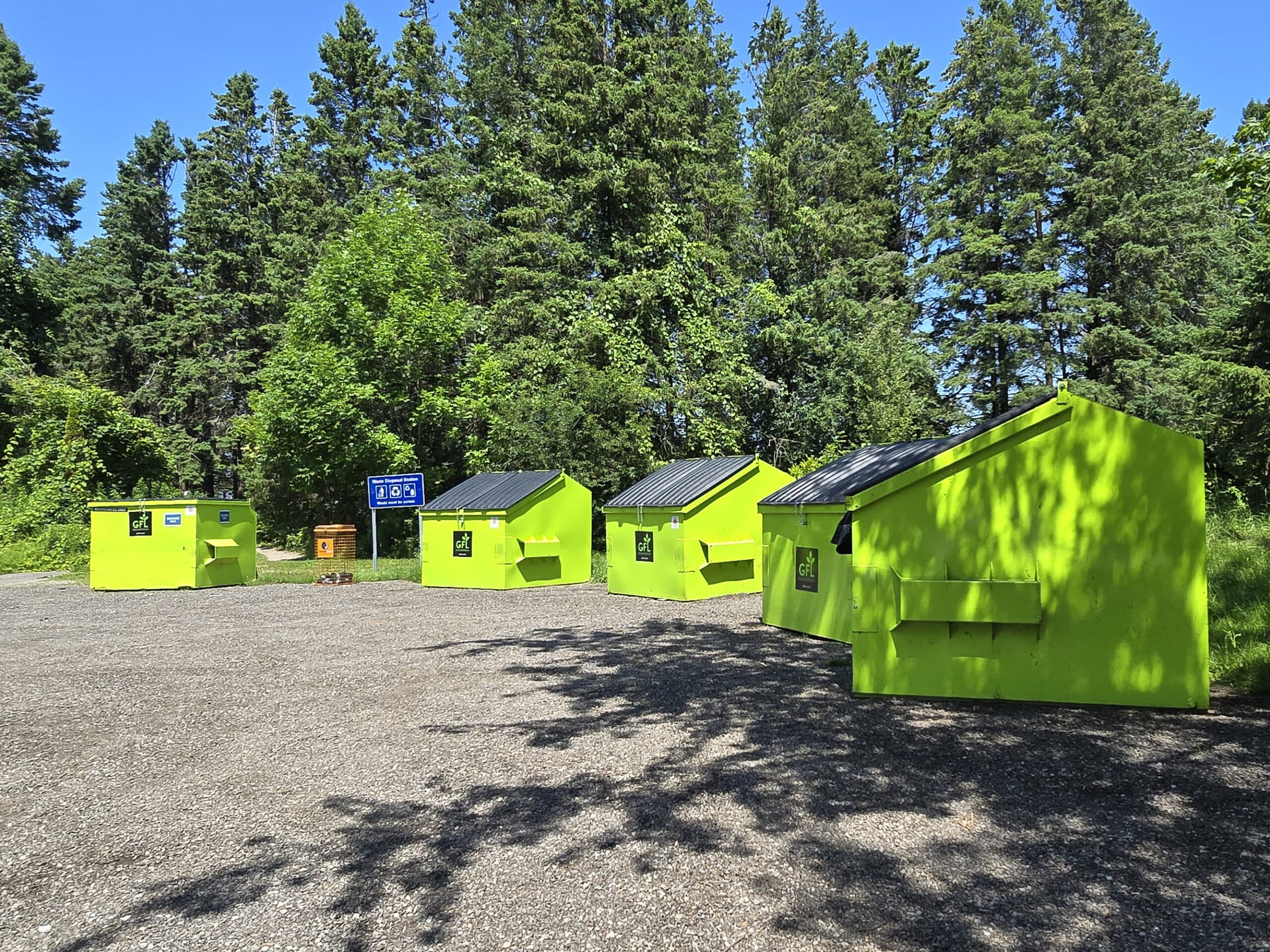 A row of brightly coloured garbage bins.