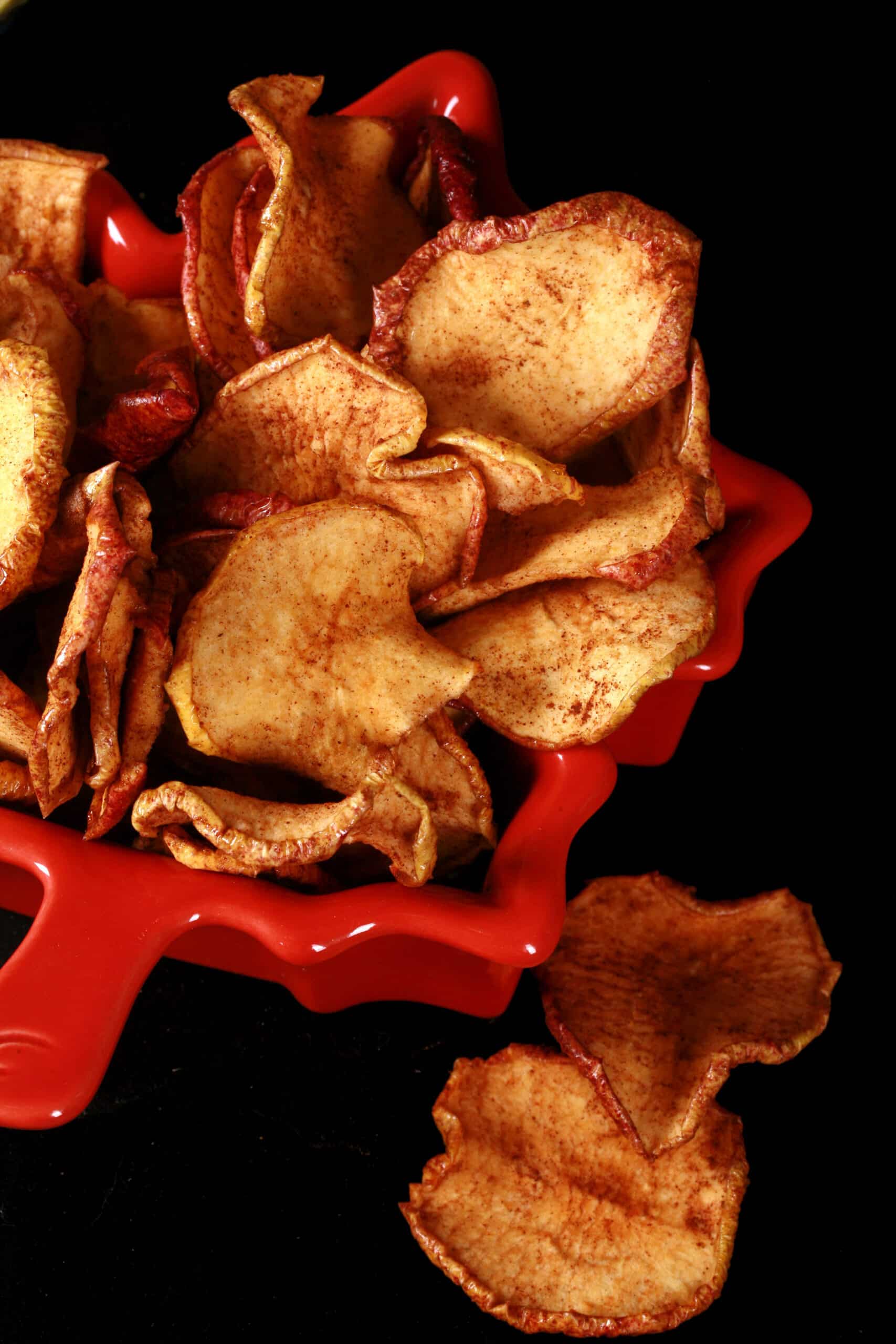 A bowl of homemade maple cinnamon apple chips.