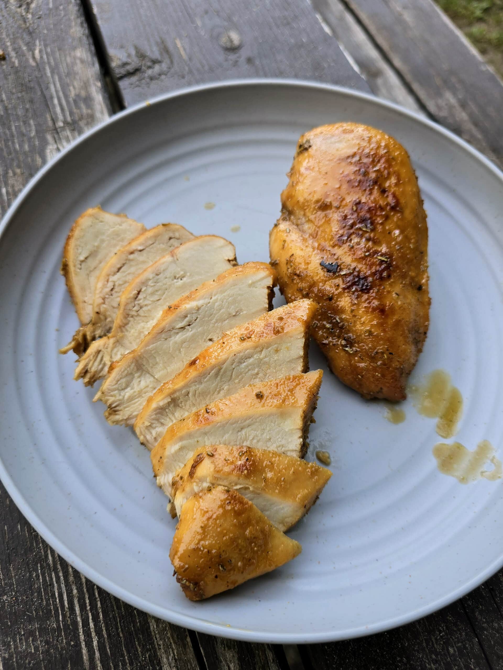 2 rosemary maple chicken breasts on a plate.