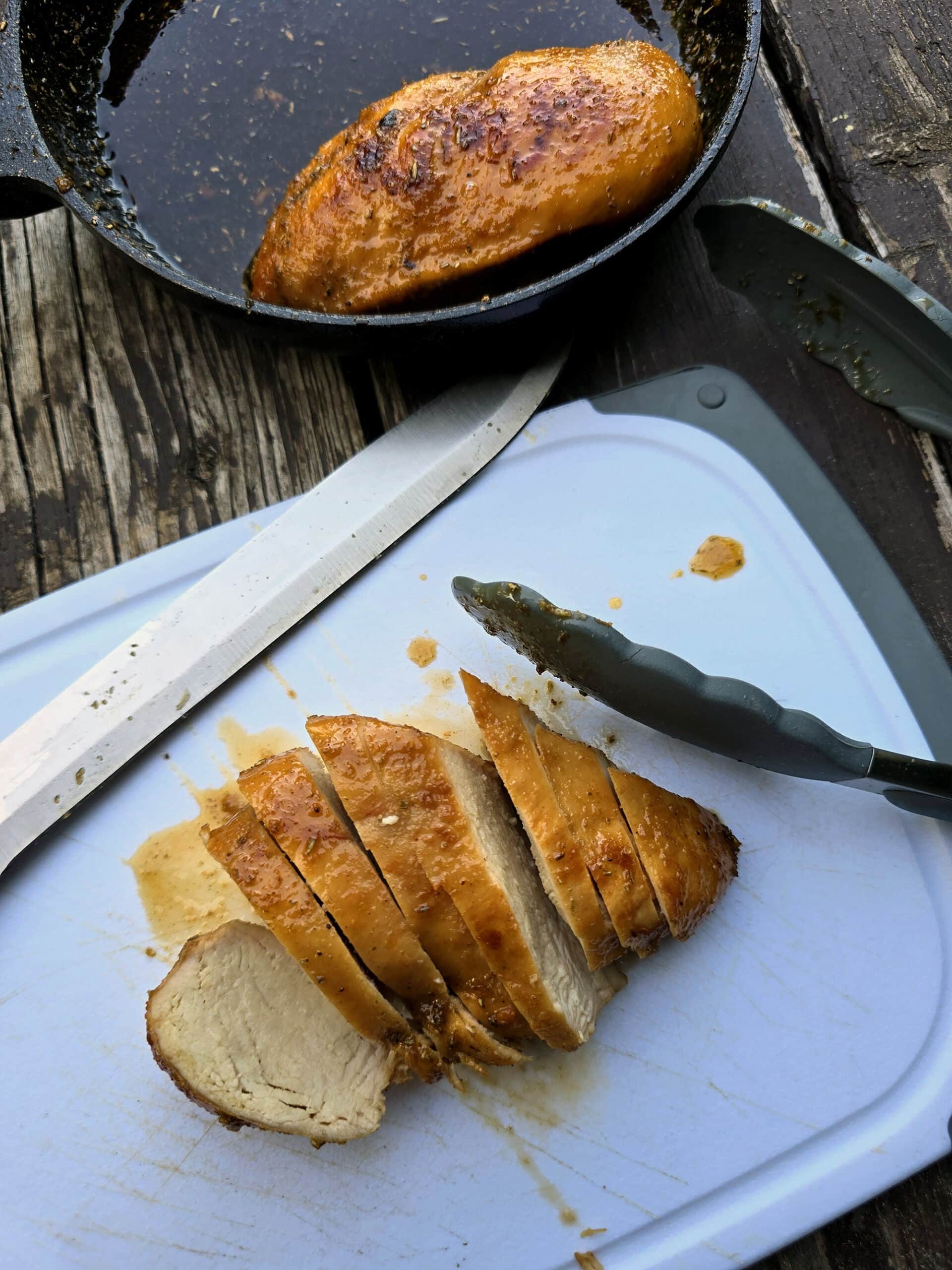 A rosemary maple syrup glazed chicken breast being sliced up.