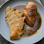 2 rosemary maple chicken breasts on a plate.