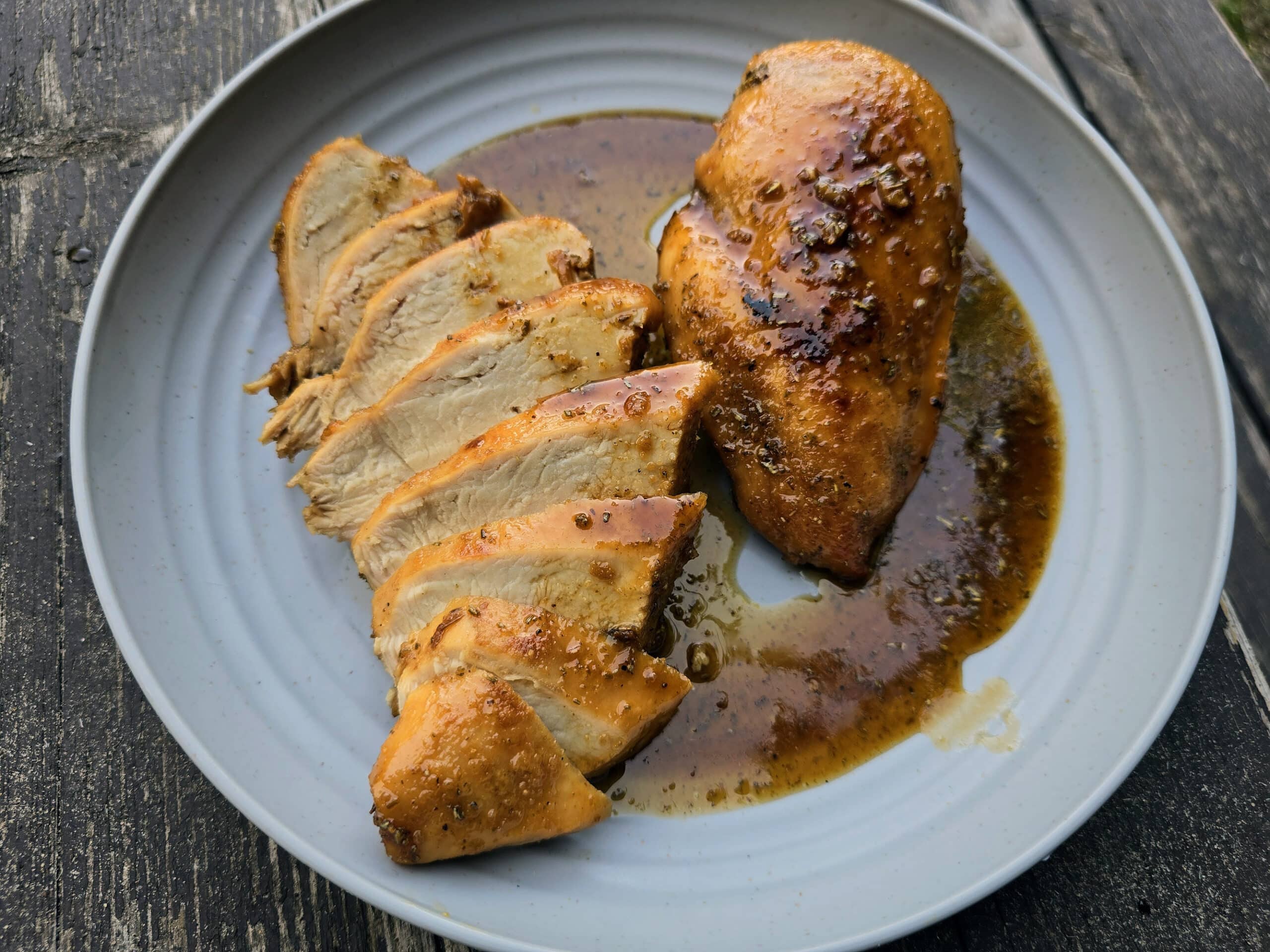 2 rosemary maple chicken breasts on a plate.