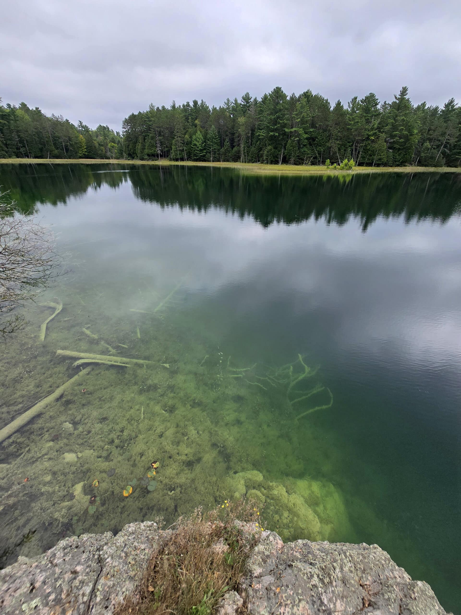 McGinnis Lake, a bright turquoise meromictic lake at Petroglyphs Provincial Park.