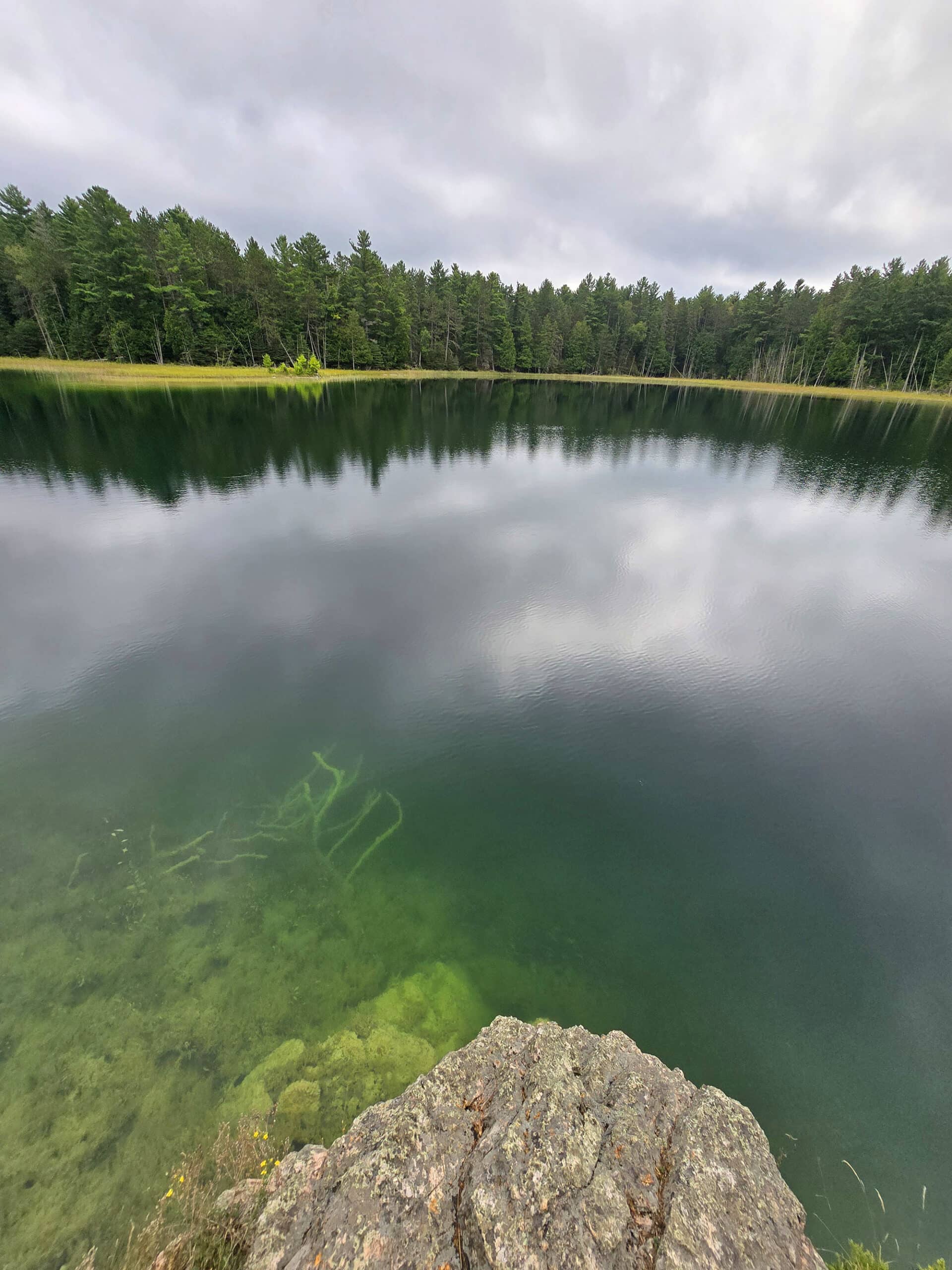 McGinnis Lake, a bright turquoise meromictic lake at Petroglyphs Provincial Park.