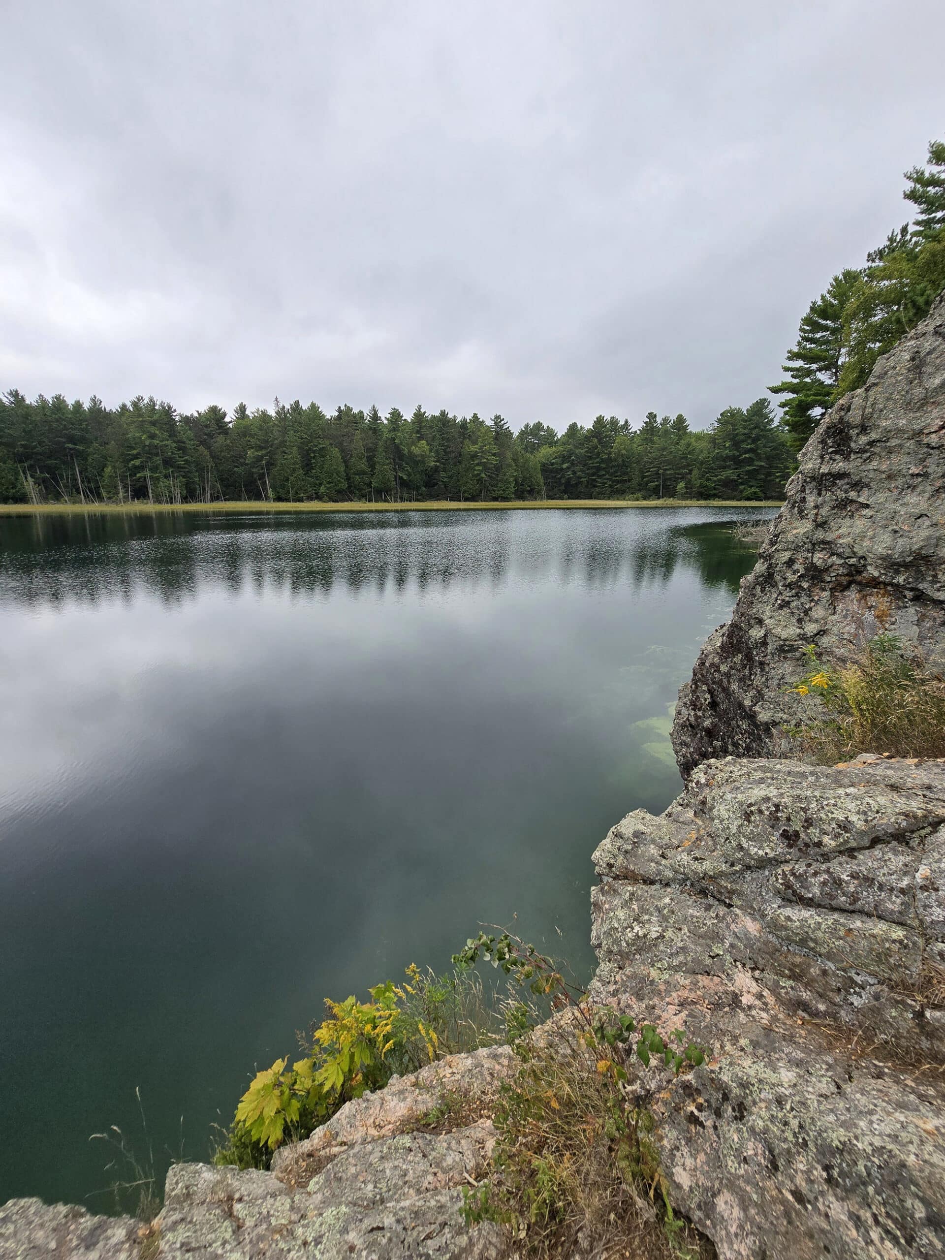 McGinnis Lake, a bright turquoise meromictic lake at Petroglyphs Provincial Park.