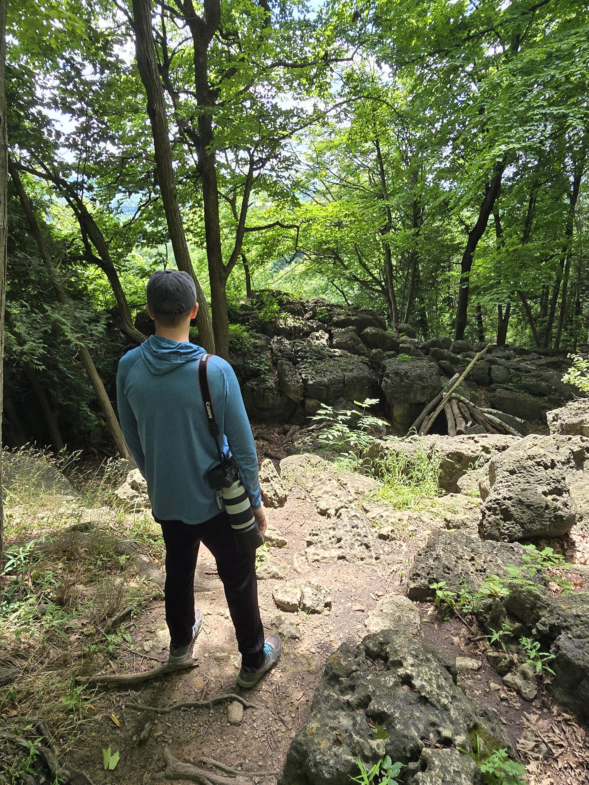 A man looking over a crevice.