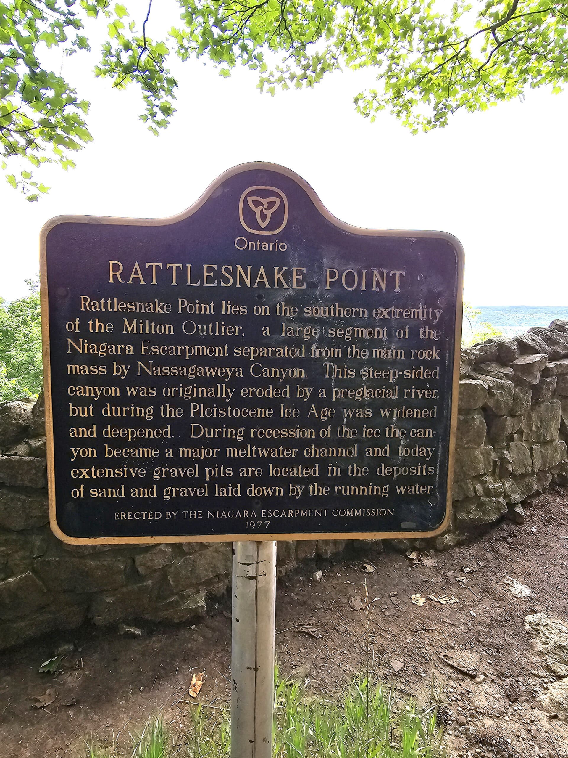 A sign talking about rattlesnake Point and how it was formed.