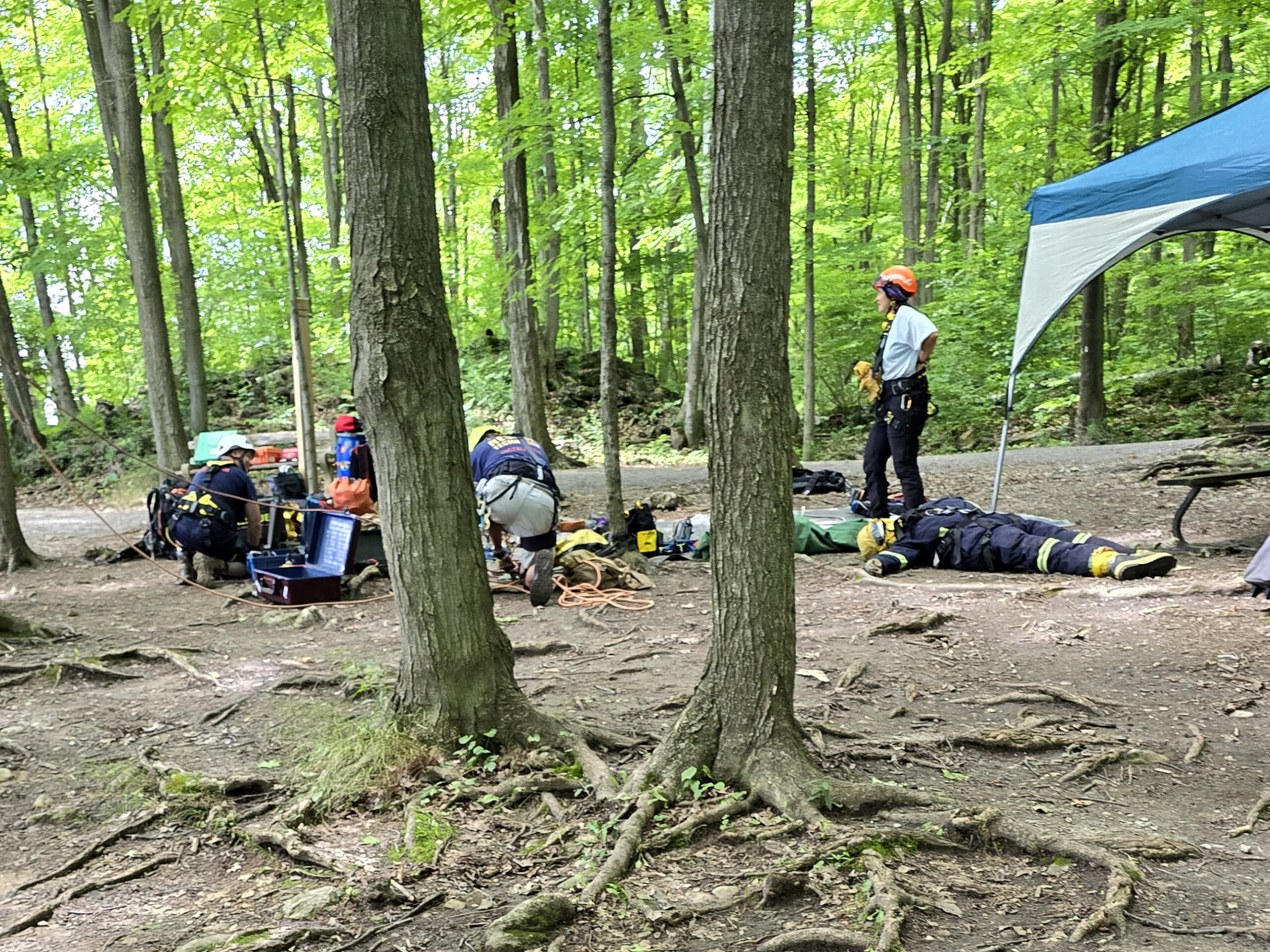 A rescue team, training at the edge of the cliff.