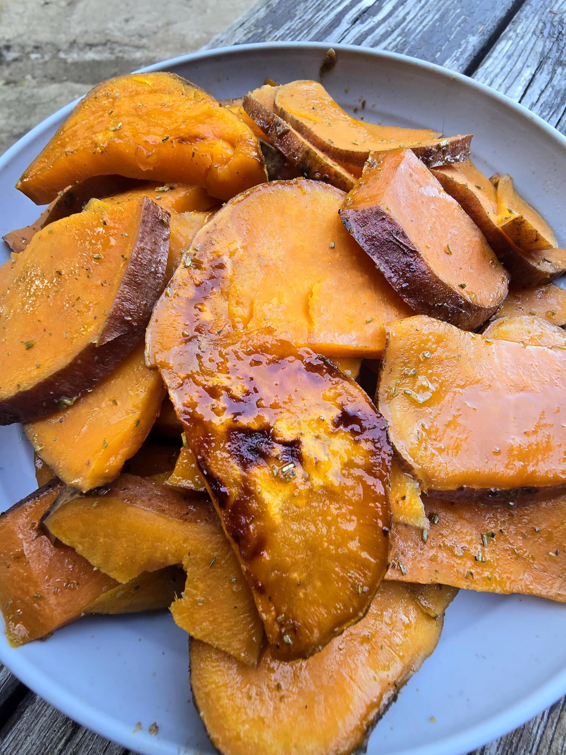 A plate of rosemary maple sweet potato slices.